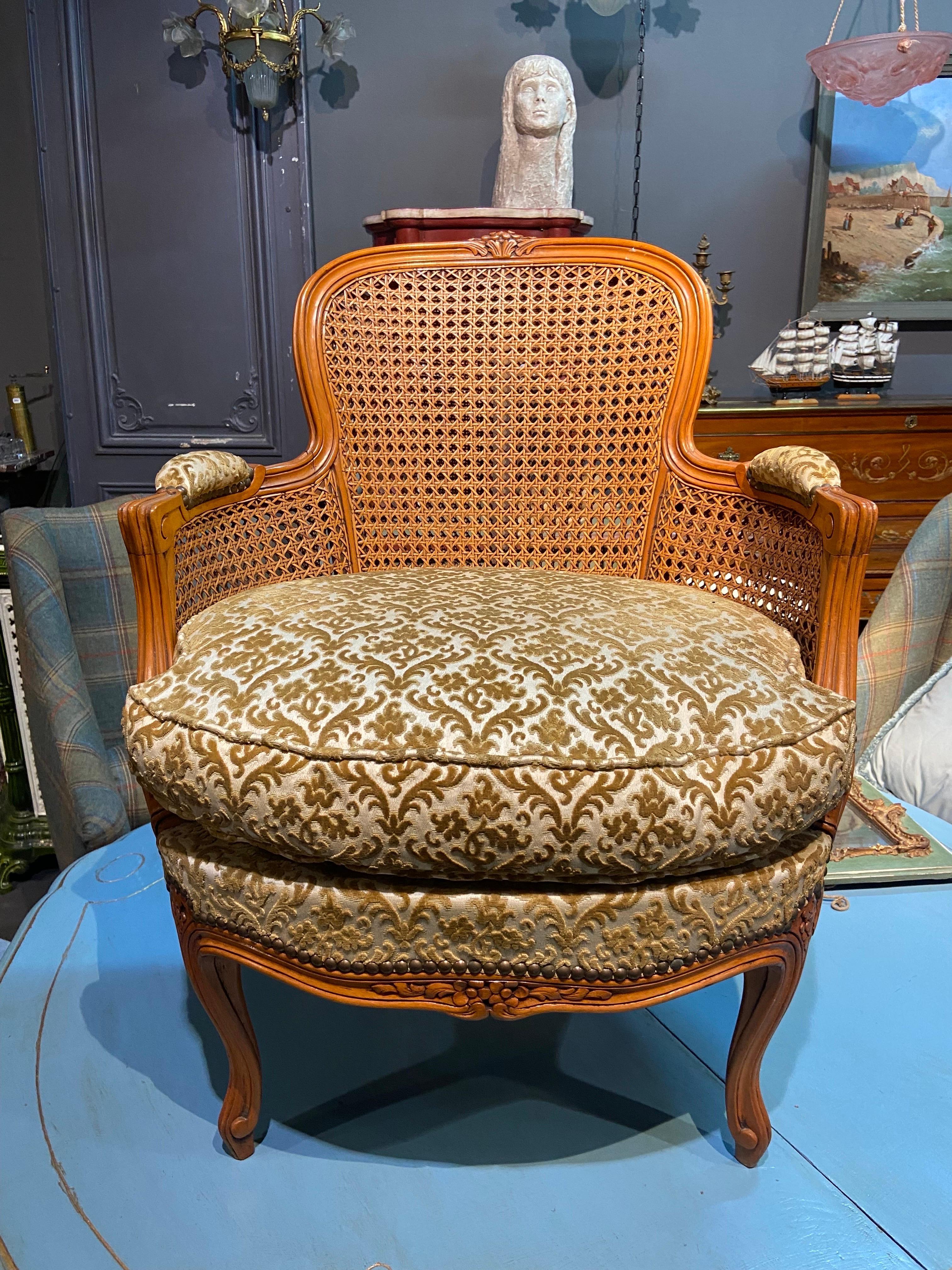 Petite French round armchair, in Louis XVI style hand carved and decorated with friezes of ribbons tapered fluted base, with dobble cane back and sides. Upholstered in mustard velvet. Very good condition. 
France, circa 1880.