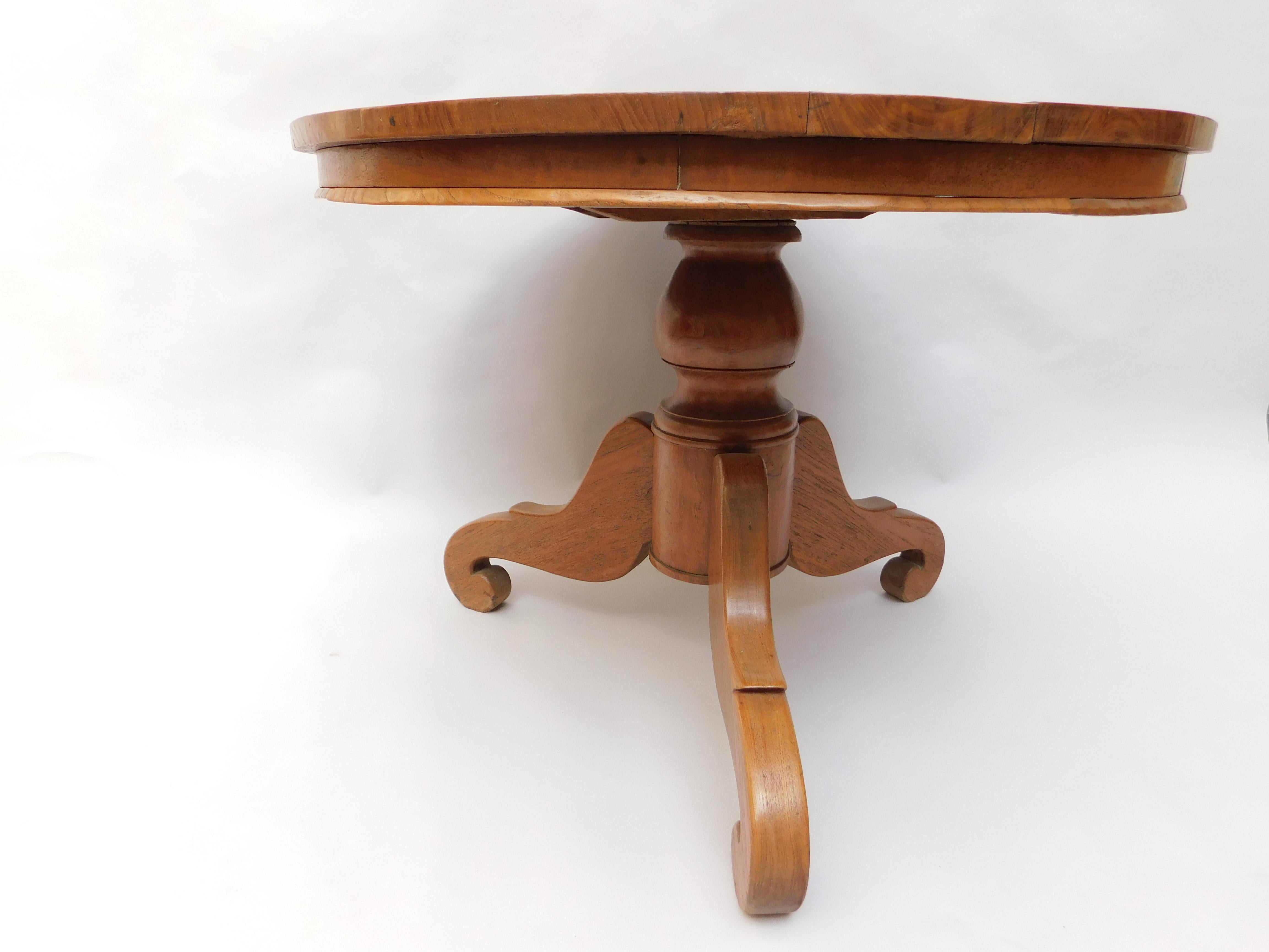 Mid-19th century French pedestal table constructed from solid cherry wood. Tripod base of solid carved cherry urn shaped pedestal supported by three curvaceous legs ending in curled feet.
The crack in the base is a normal sign of ageing and