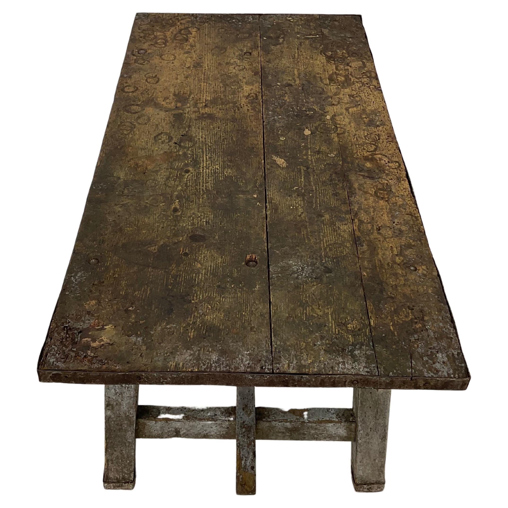 19th century French industrial, rustic writing table or desk. Soundly constructed, all wood top with iron strap around entire edge and bottoms of legs. Trestle base.  Multi purpose table can be used in any room as a dining table, center table or a