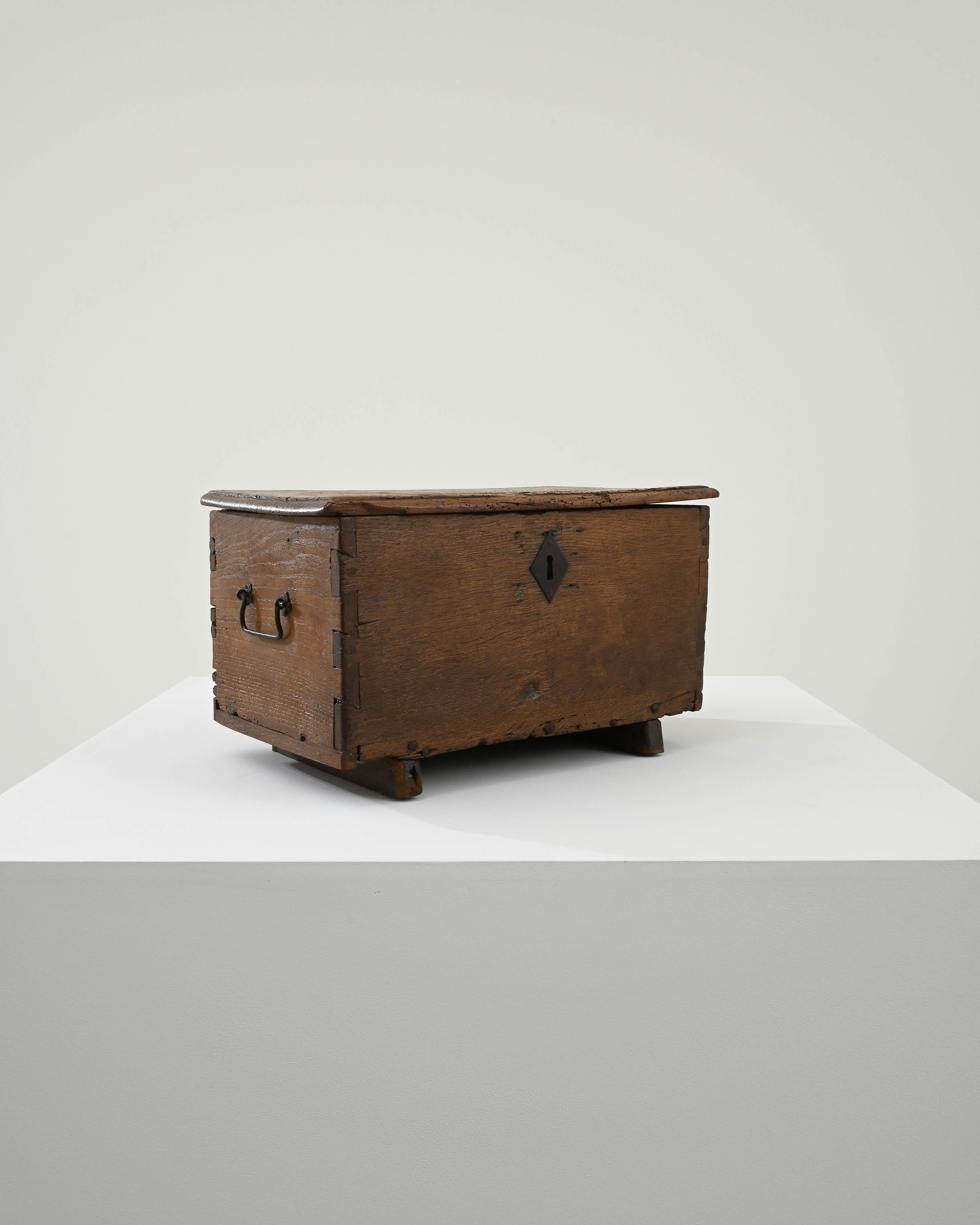 A wooden trunk created in 19th century France. A reminder of simple times, this small wooden trunk exudes a sense of authenticity with a time-touched patina. The surface of the oak is covered with tales of its past. Assembled with box joinery and
