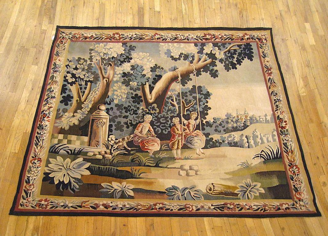 A French rustic genre tapestry from the 19th century, centrally woven, portraying young nobles at play in an opulent courtyard, with a young man pushing a young lady on a swing as another lady with a dog looks on, seated beside a fountain and