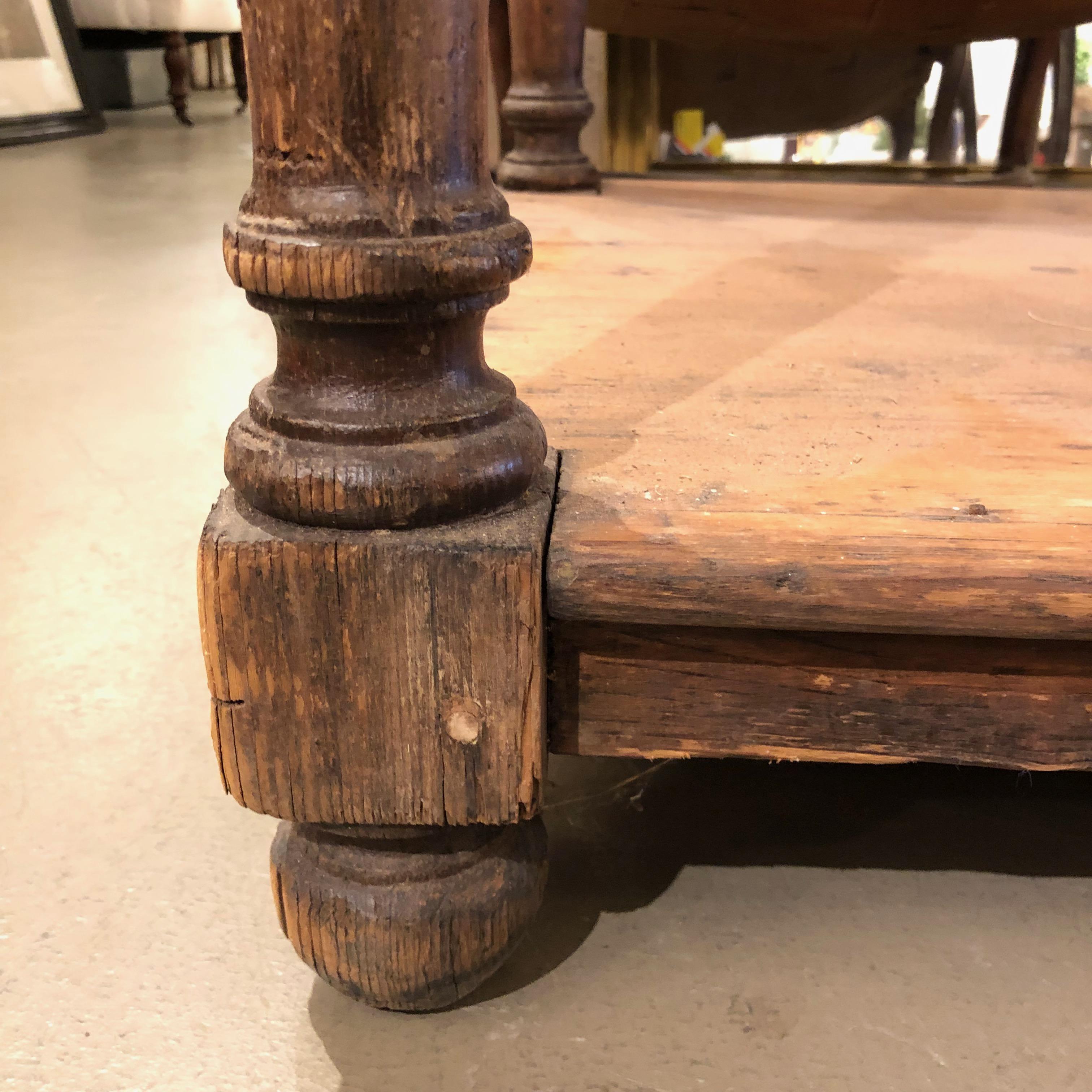 A 19th century French rustic two-tier oak pastry table with a marble top resting on carved and turned legs.