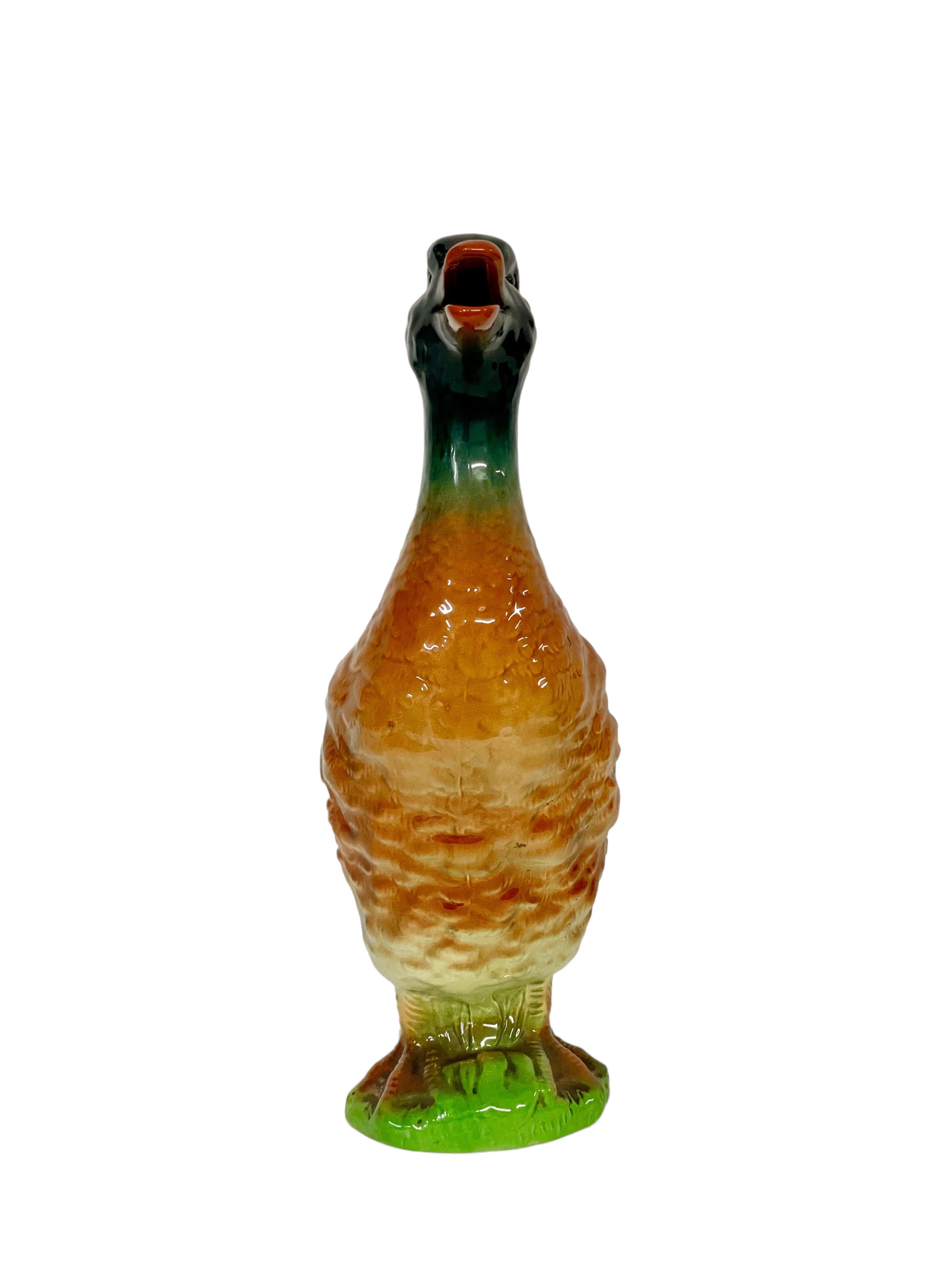 An unusual and very quirky vintage Majolica barbotine water or wine pitcher in the shape of a mallard duck, made by Keller et Guérin's earthenware factory at Saint Clément, near Lunéville, in north-eastern France around the turn of the 20th century.
