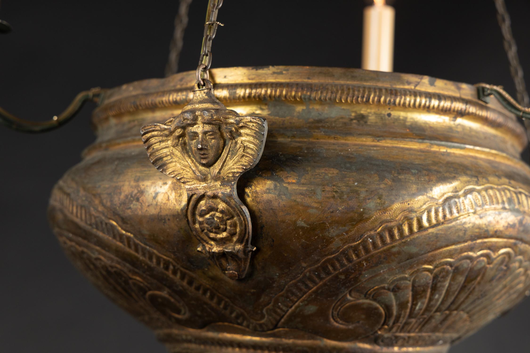 This unique hanging lantern was once an incense burning sanctuary lamp, and is made of brass sporting a beautiful patina. The French antique piece dates back to the 19th century and is embellished with hand-chiseled Moorish designs on the large