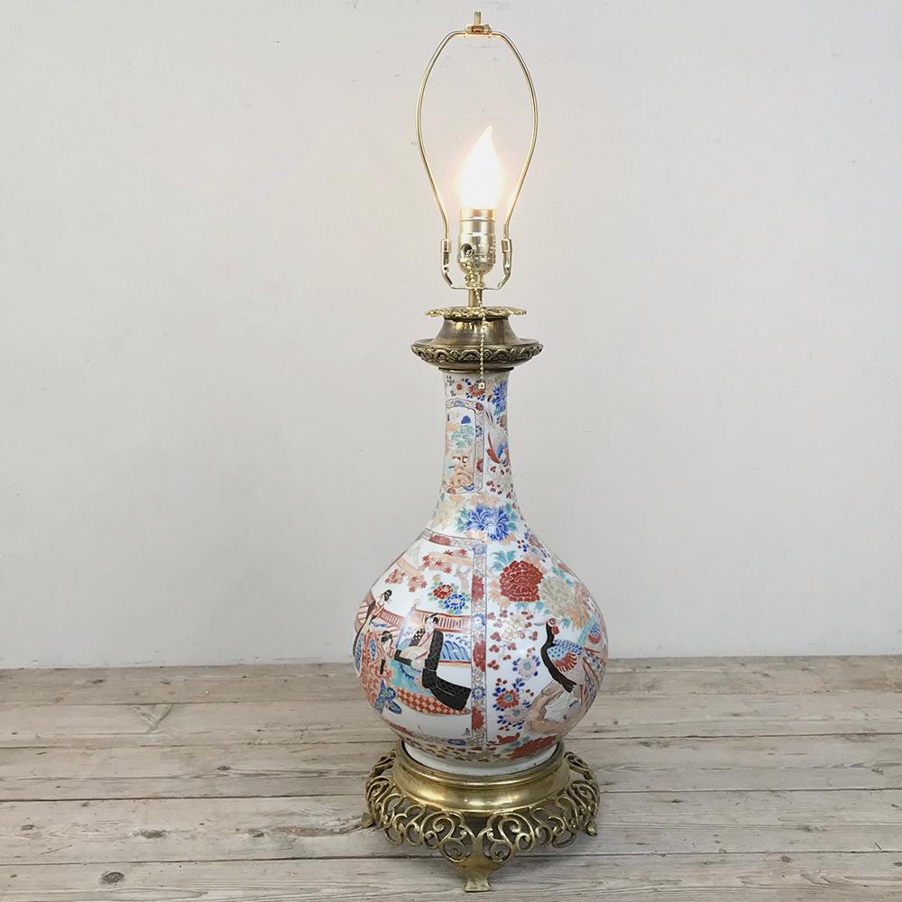 19th century French Satsuma urn table Lamp features hand-painted artistry protected by a proprietary glaze that made such artifacts all the rage in 18th & 19th century Europe! This example sits on a French solid bronze base with a bronze cap at top,