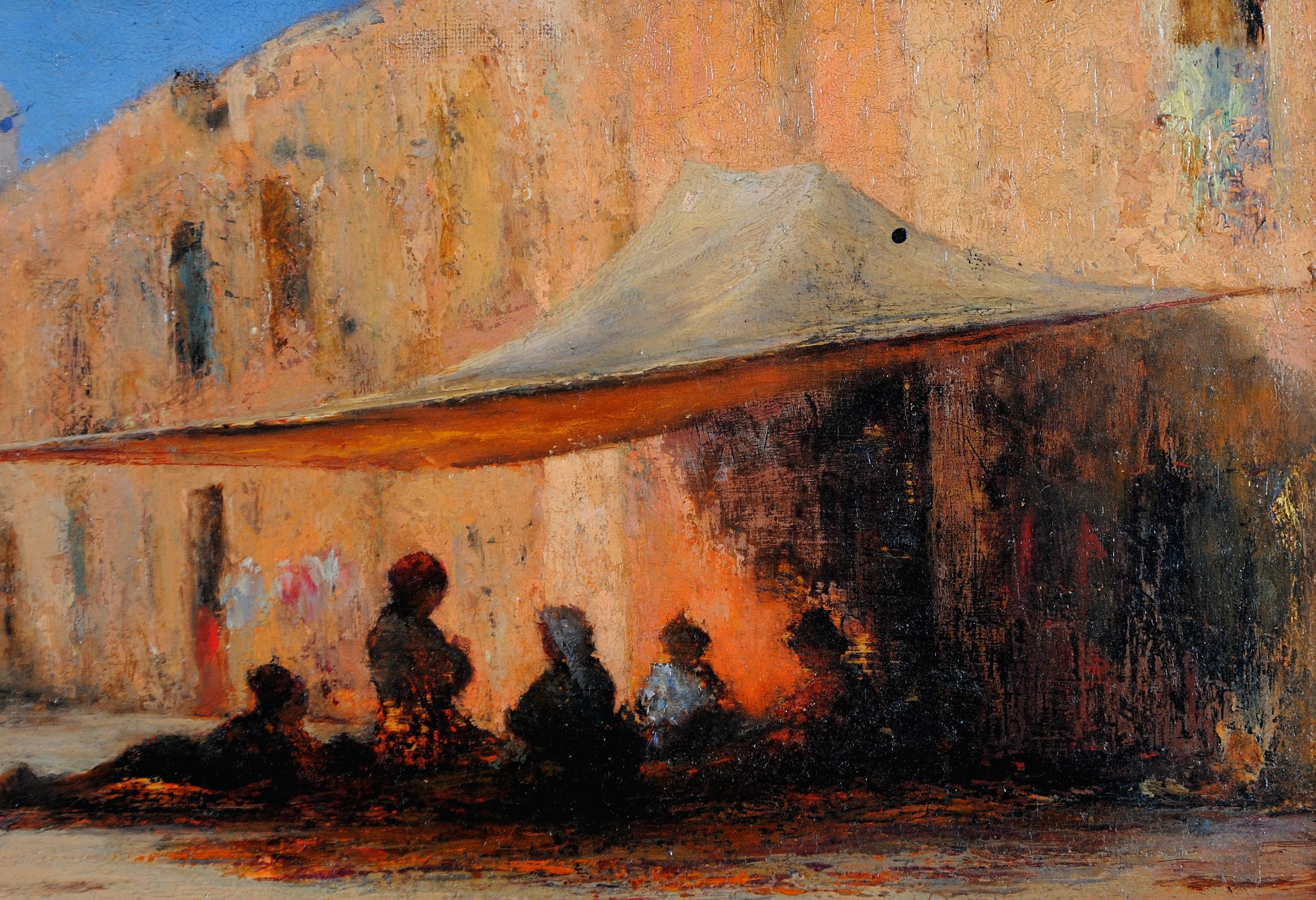A beautiful late 19th century French Orientalist oil on panel depicting a North African street with figures seated under an awning. Perhaps the location is the pink city of Marrakesh in Morocco.

The work is very well painted and atmospheric.