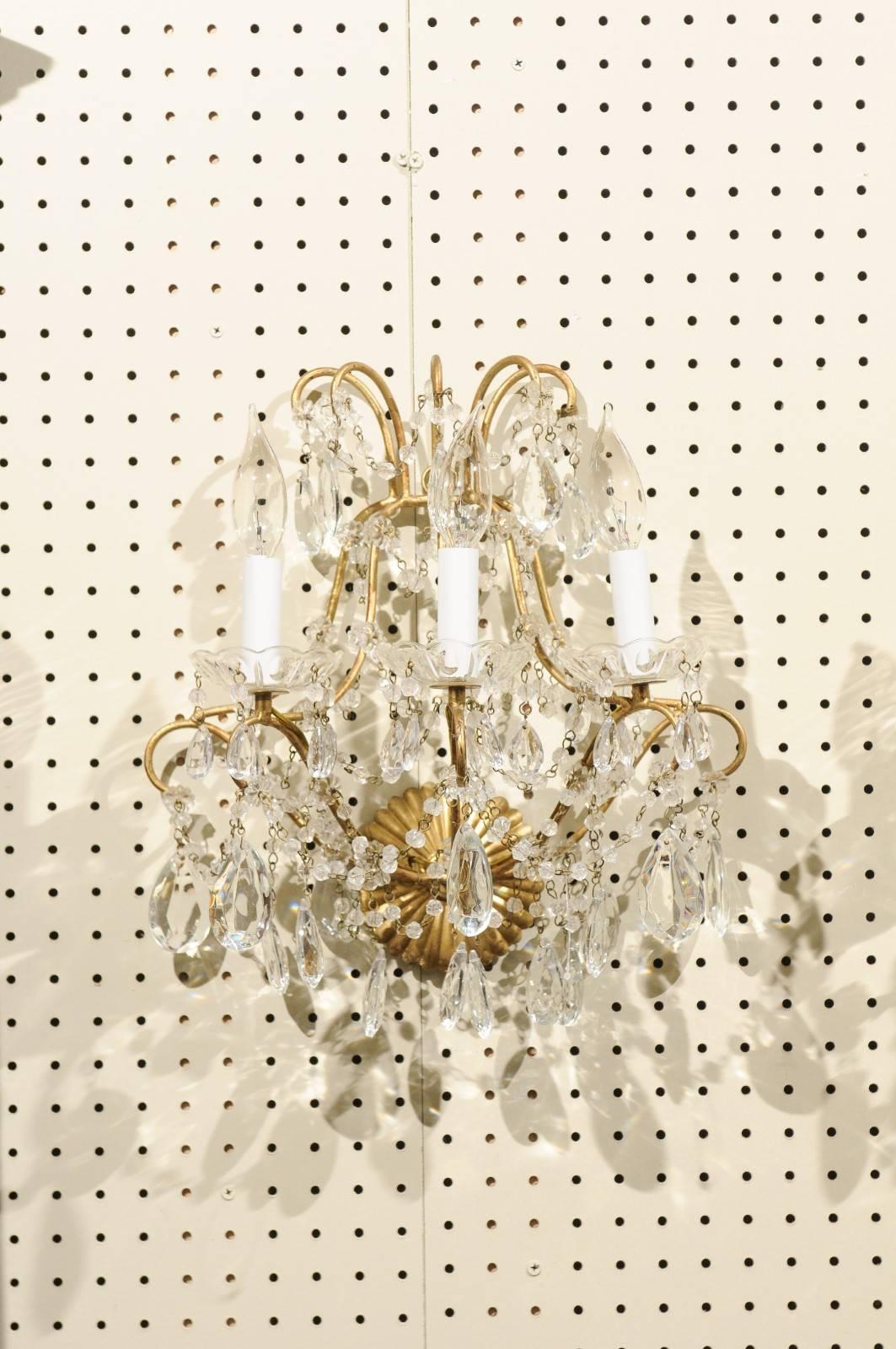 A beautiful pair of Napoleon 111 French brass and crystal wall sconces. Each with three electrified candle lights.
The crystal are original and vary in size and shape.