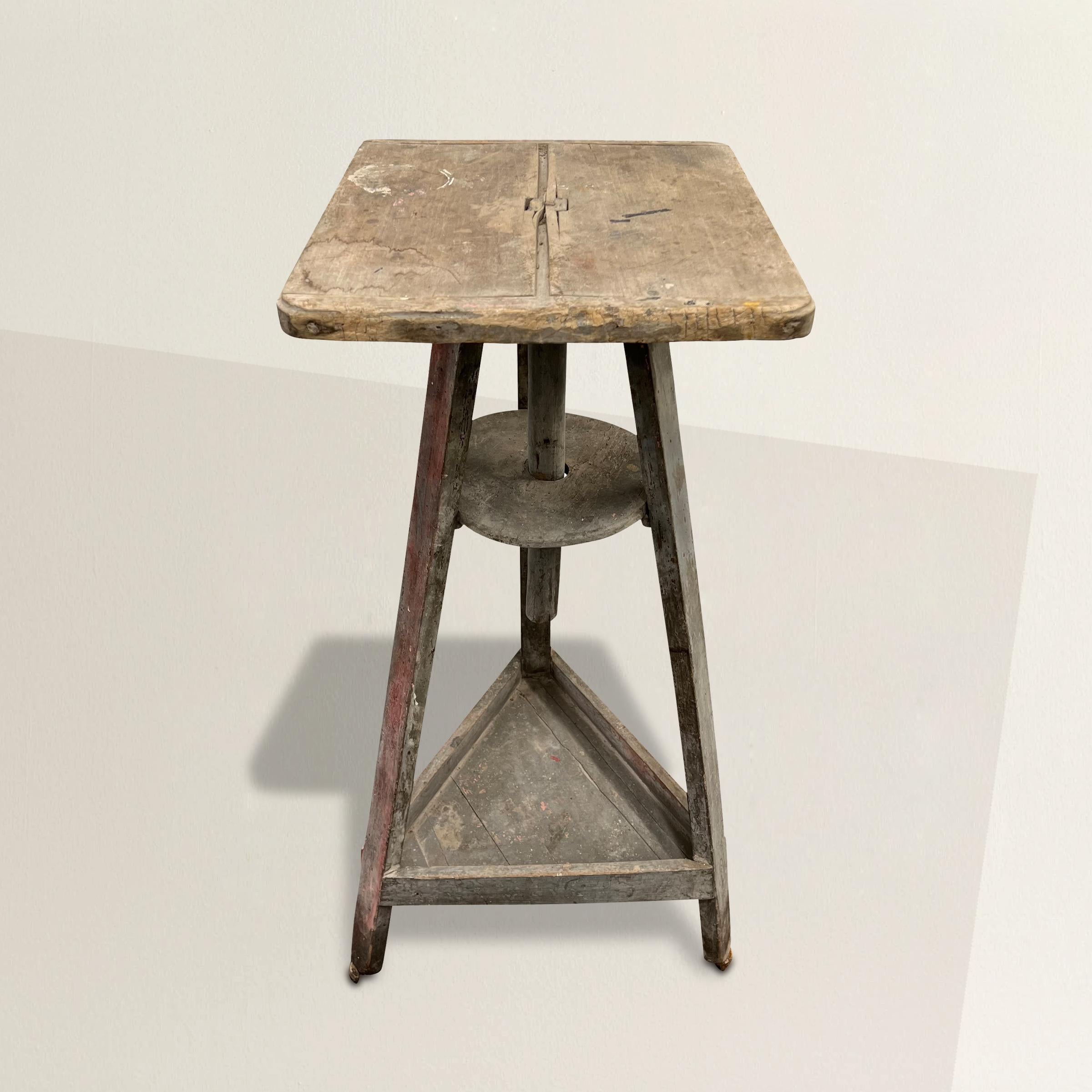 A chic 19th century French sculptor's stand with rotating wood top set over three splayed legs with a shelf at the bottom, and all finished with its original gray/blue paint.  The perfect pedestal for your favorite sculpture, objet d'art, or plant!