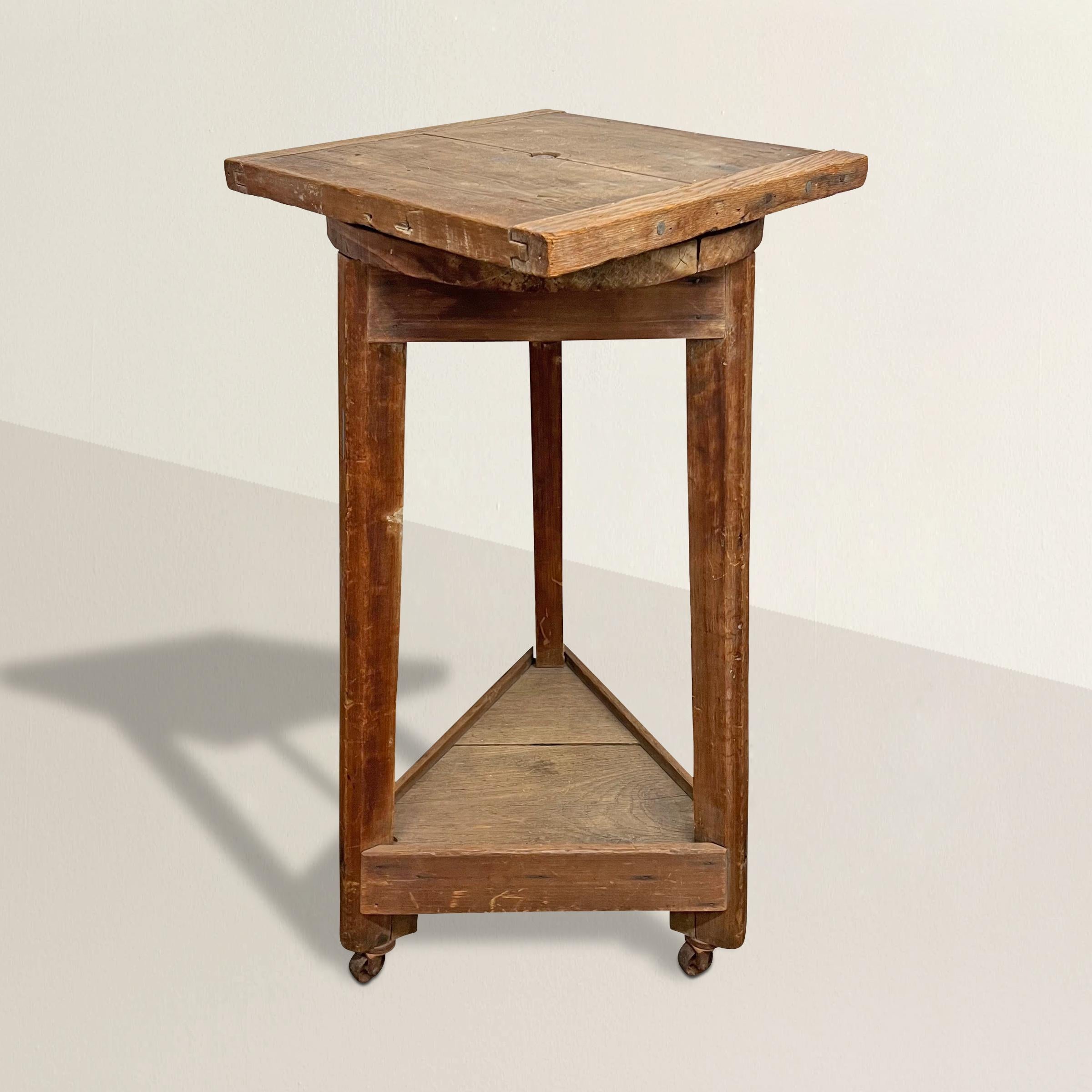 A wonderful 19th century French oak and pine sculptor's stand with a top that rotates around a peg, and a shelf at the bottom originally used to store the artist's tools. Today is the perfect pedestal to display your favorite sculpture or piece of