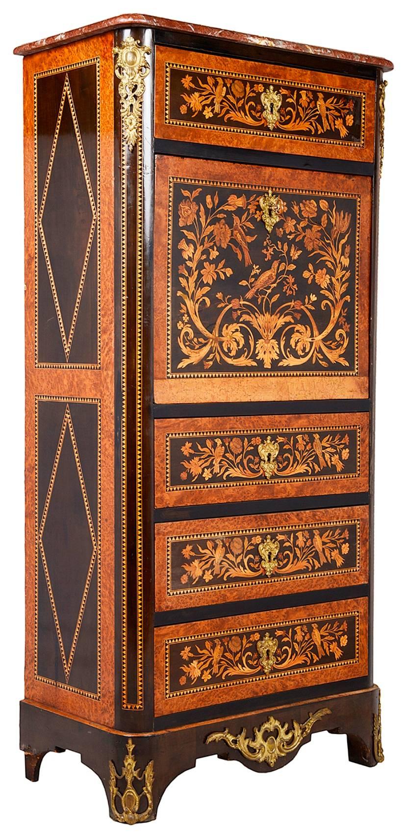 A good quality Louis XVI style marquetry inlaid Secretaire Abattant. Having a Rouge marble top, profuse scrolling floral inlay to the front. A single drawer to the top, the fall front opening to reveal fitted inlaid drawers and an inset writing