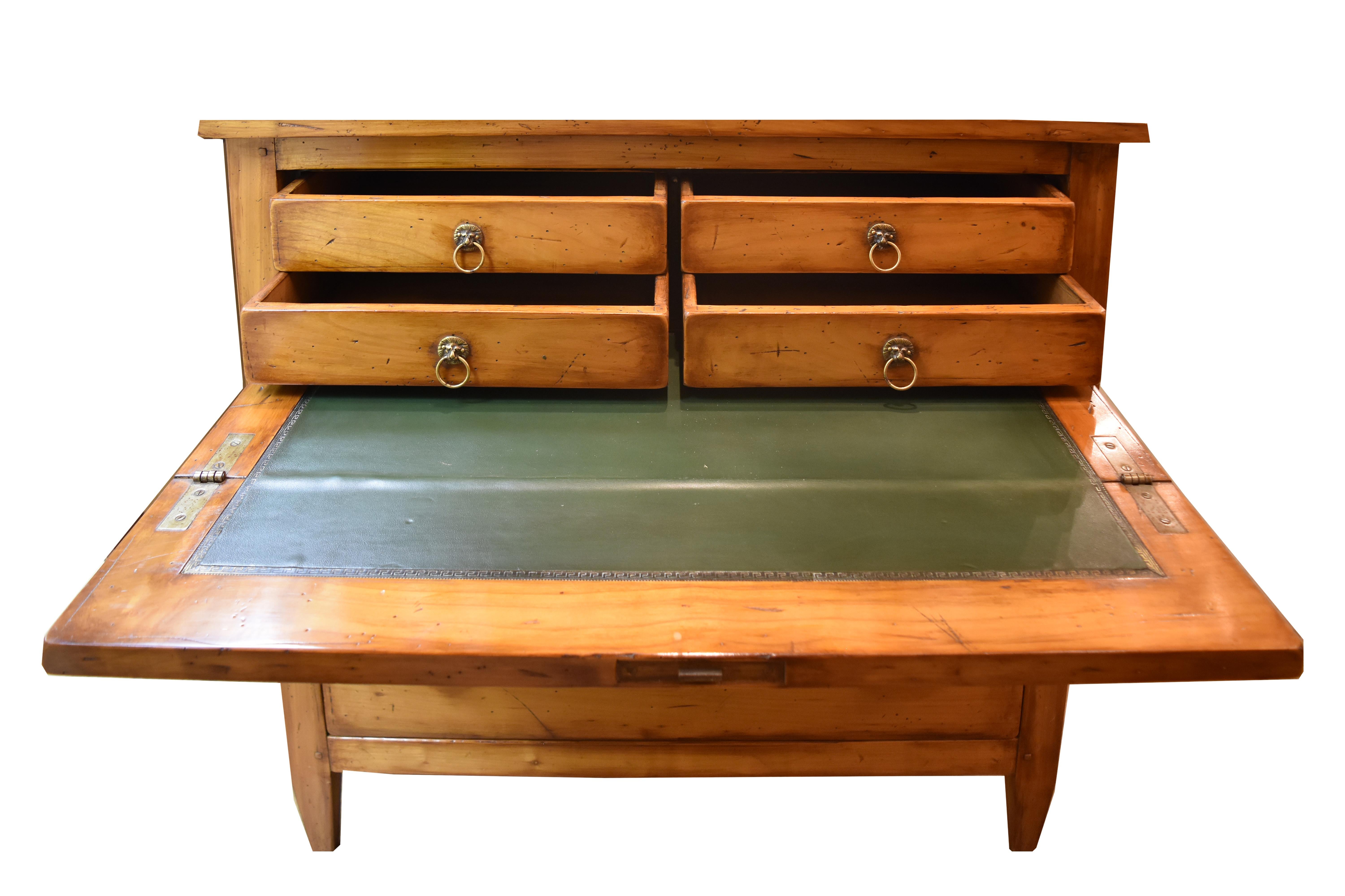 This 19th century narrow French Secretaire features a top drawer which opens to reveal a desk and four operable drawers. The Secretaire writing surface is green leather. The middle drawer is actually a cabinet and is hinged from the bottom. The only