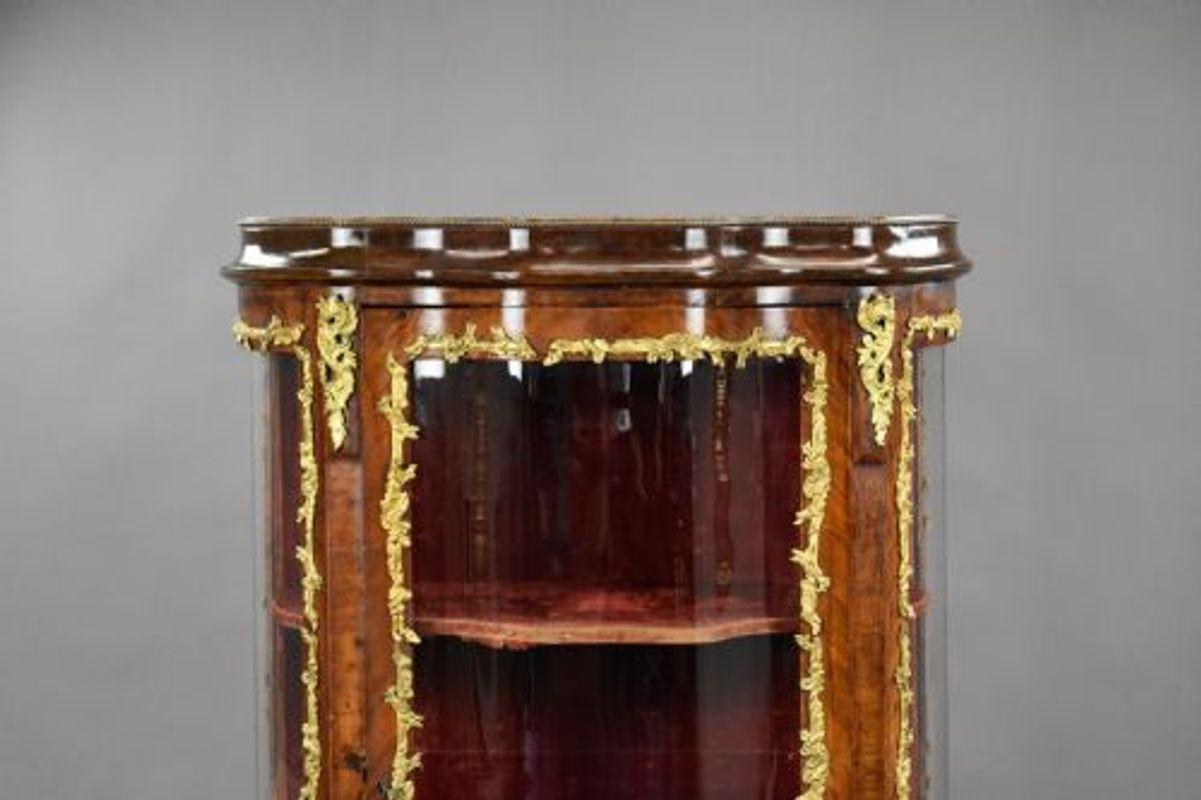 For sale is a good quality 19th century French serpentine vitrine, having a central glazed door decorated with ormolu mounts opening to a velvet lined interior the cabinet stands on two elegantly shaped feet to the front and remains in good
