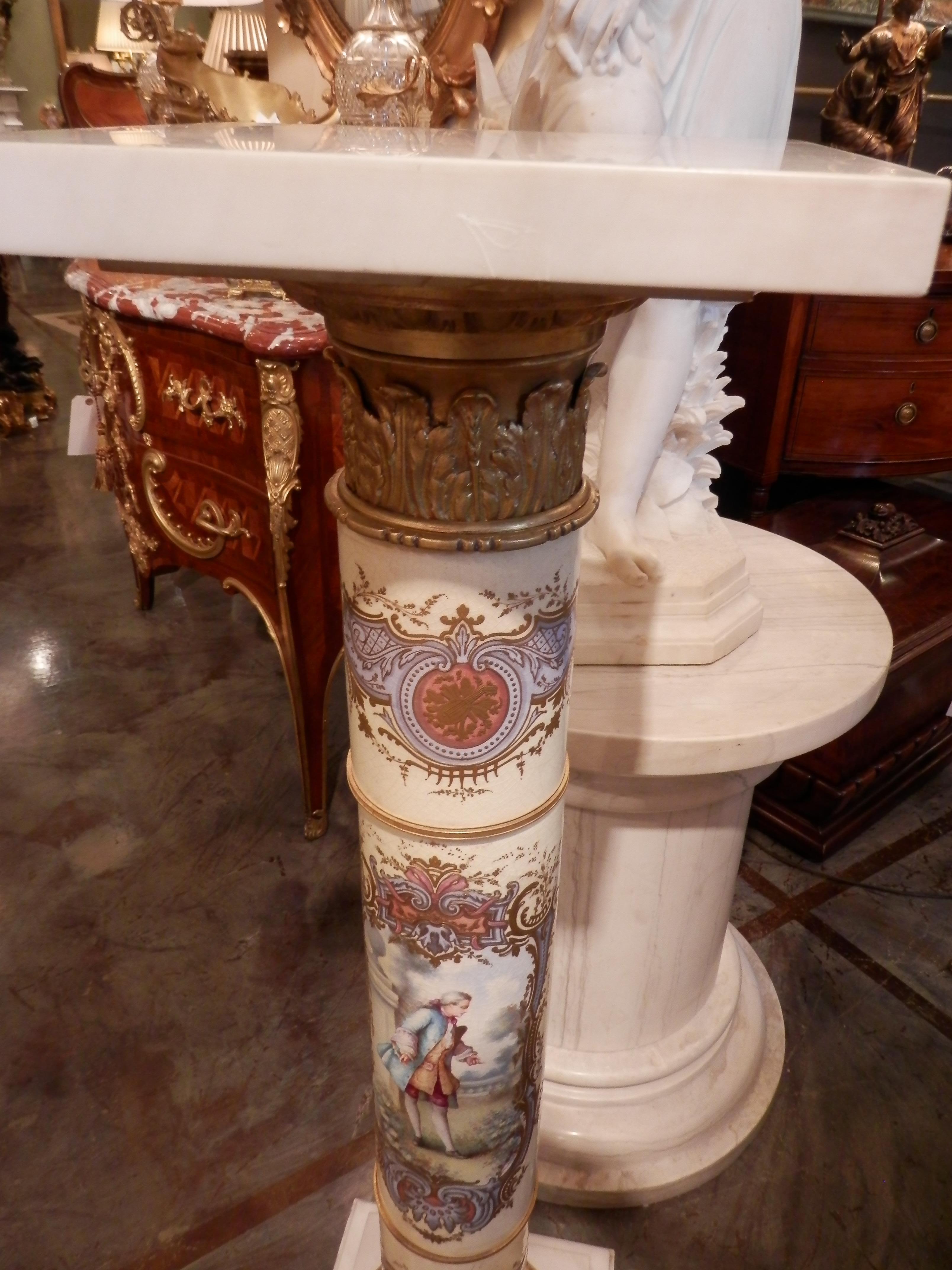 A fine 19th century French Serve's porcelain pedestal with raised detail and fine gilt bronze mounts. Carrera marble top and base.