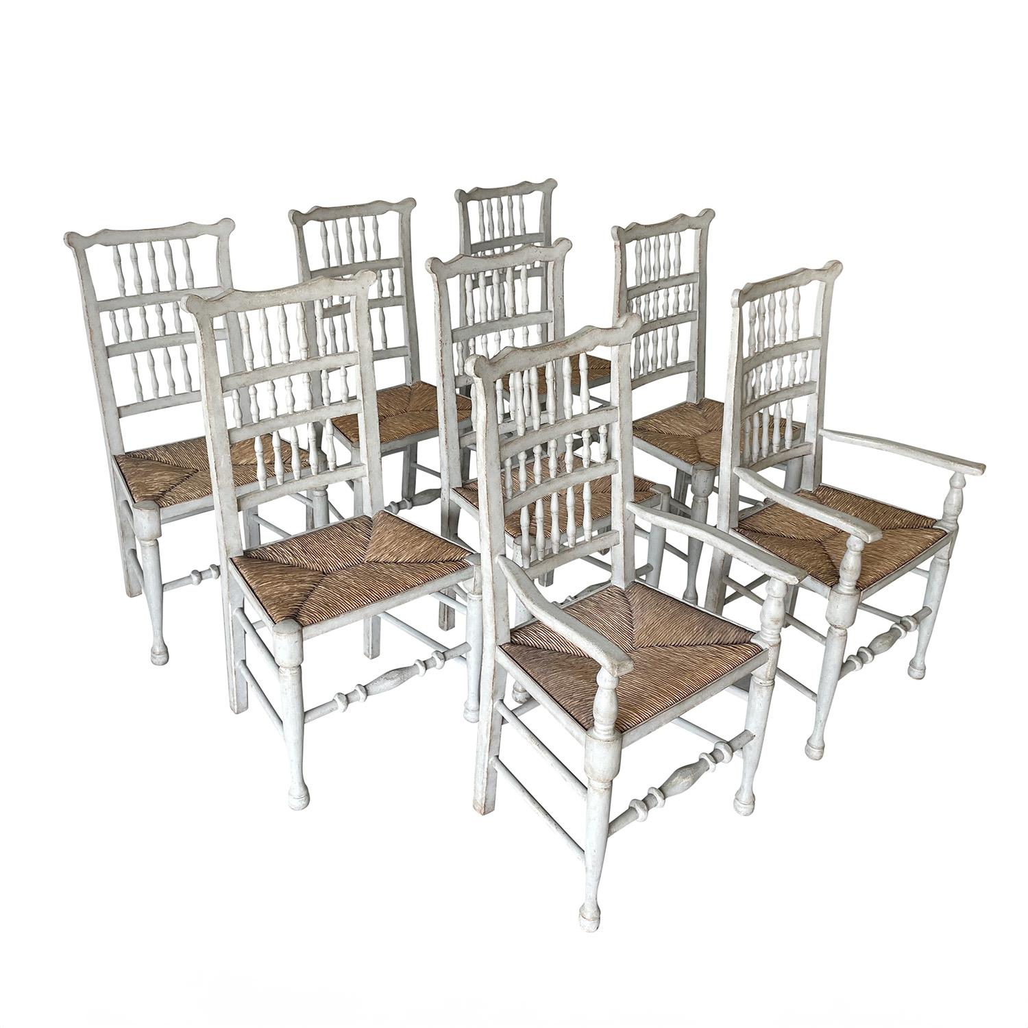 A 19th Century, antique French set of eight dining room chairs made of hand crafted painted Beechwood, in good condition. The set consists two armchairs and six side chairs. The original seat covers are made of hand braided, crafted straw. The