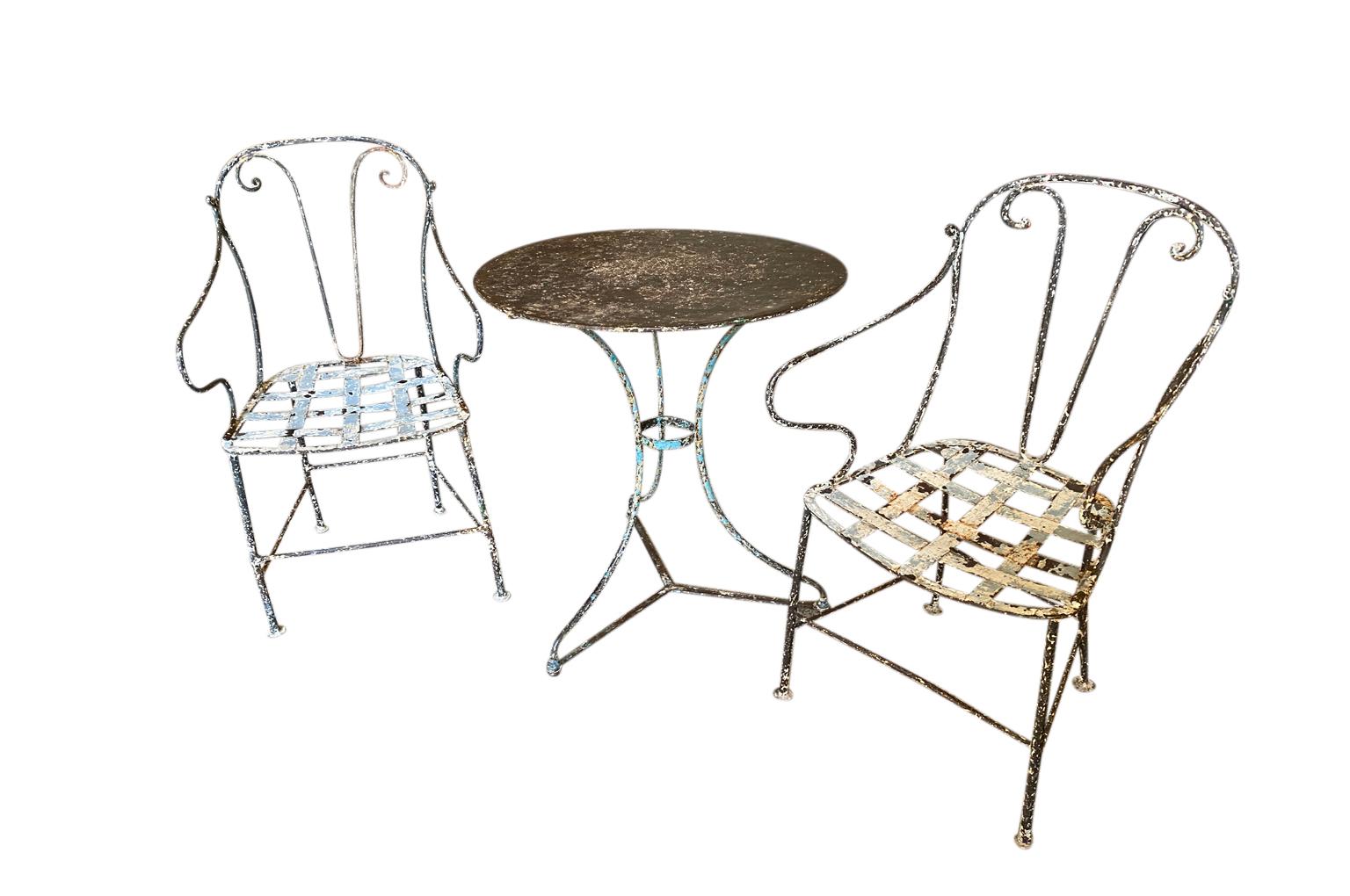A very charming set of 19th century garden table & armchairs from the Provence region of France. Wonderfully made from painted iron. Super patina. Perfect for a casual interior or garden. The table measures 27 1/2