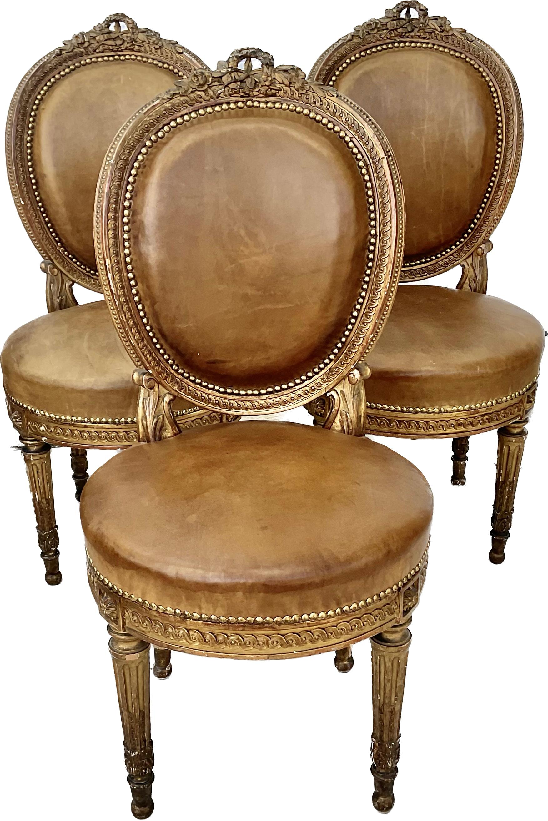 An antique French set of four Louis XVI style side chairs in giltwood finish. Stylish and elegant, perfect choice to provide timeless neoclassical styling with Fine dining comfort. The seatback frames, apron and legs feature Fine carved and molded