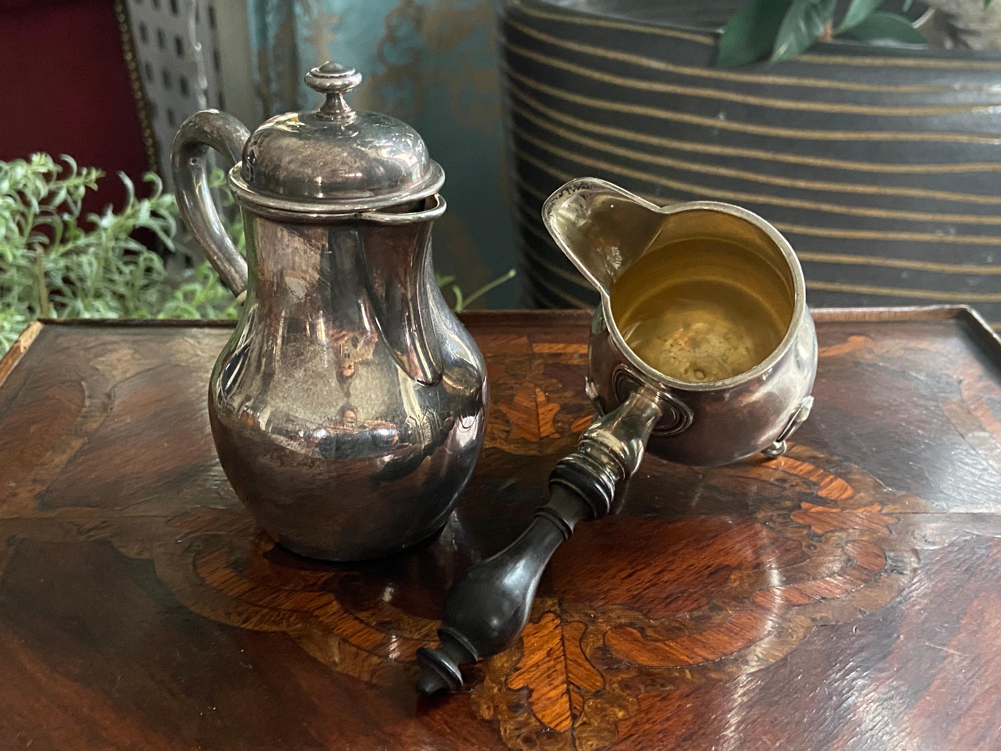 French silver set of small coffee pot and milk jug standing on three legs ending in delicate claws with wooden hand curved handle. Very good condition.
19th century.

 