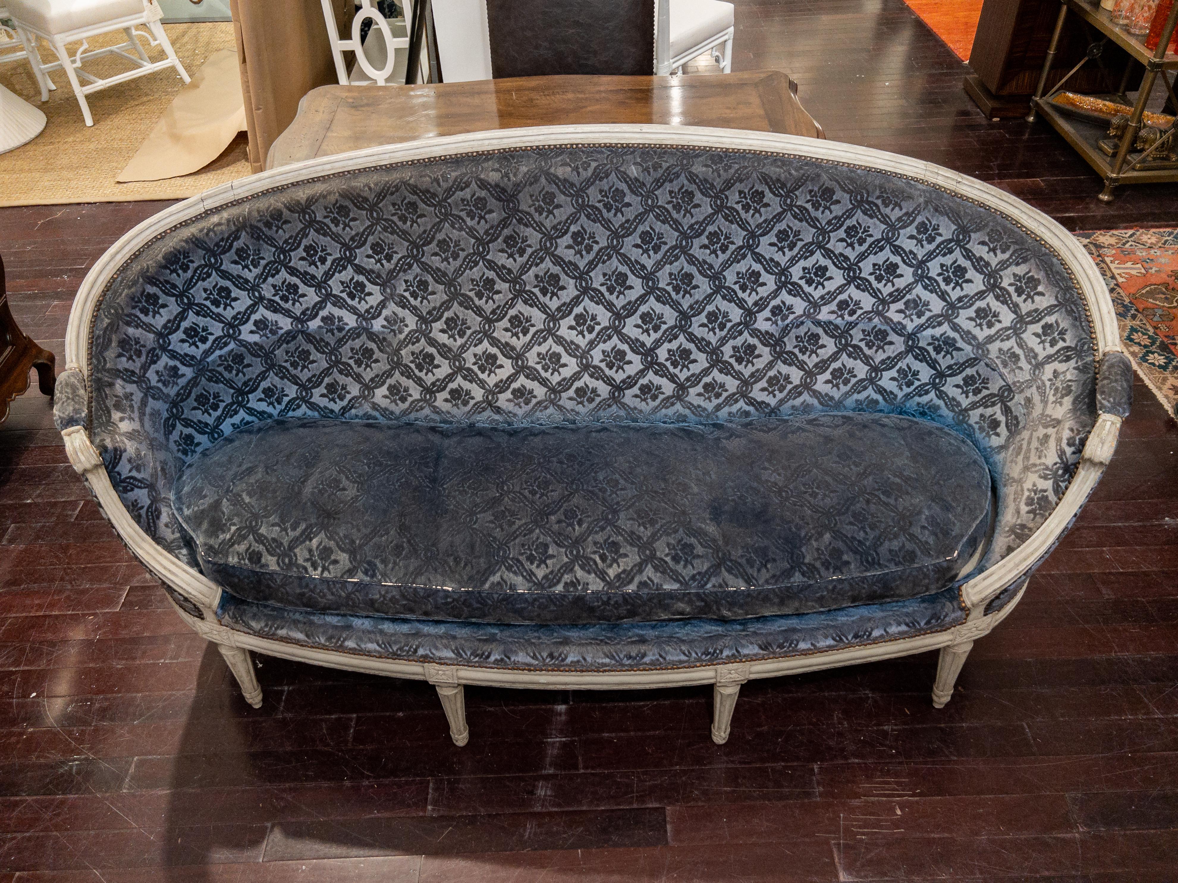 19th century French Settee, hand carved and Painted Louis XVI Style

This stunning blue settee features an intricately hand carved frame, carved reeded legs, ovoid shape, and desirable authentic distress / weathered finish to the frame from use