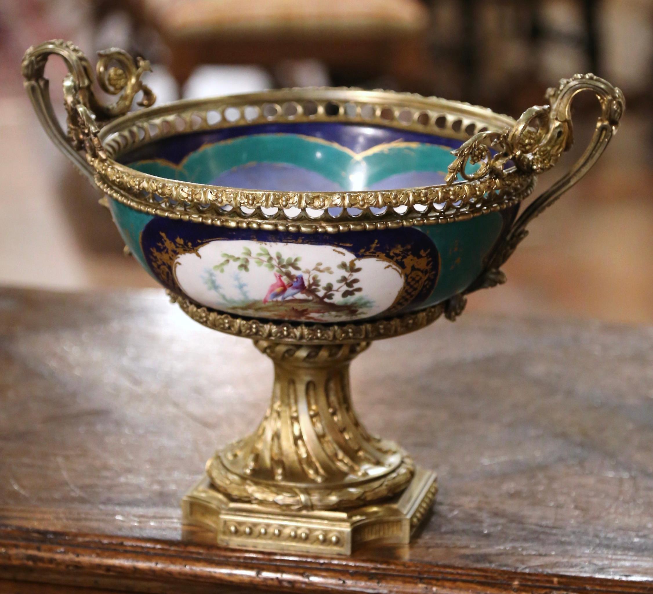 Attributed to the Manufacture de Sevres this elegant, antique jardinière was crafted in Paris, France, circa 1860. Standing on a twisted bronze dore base, the colorful centerpiece is dressed with a pierced bronze gallery rim and elegant intricate