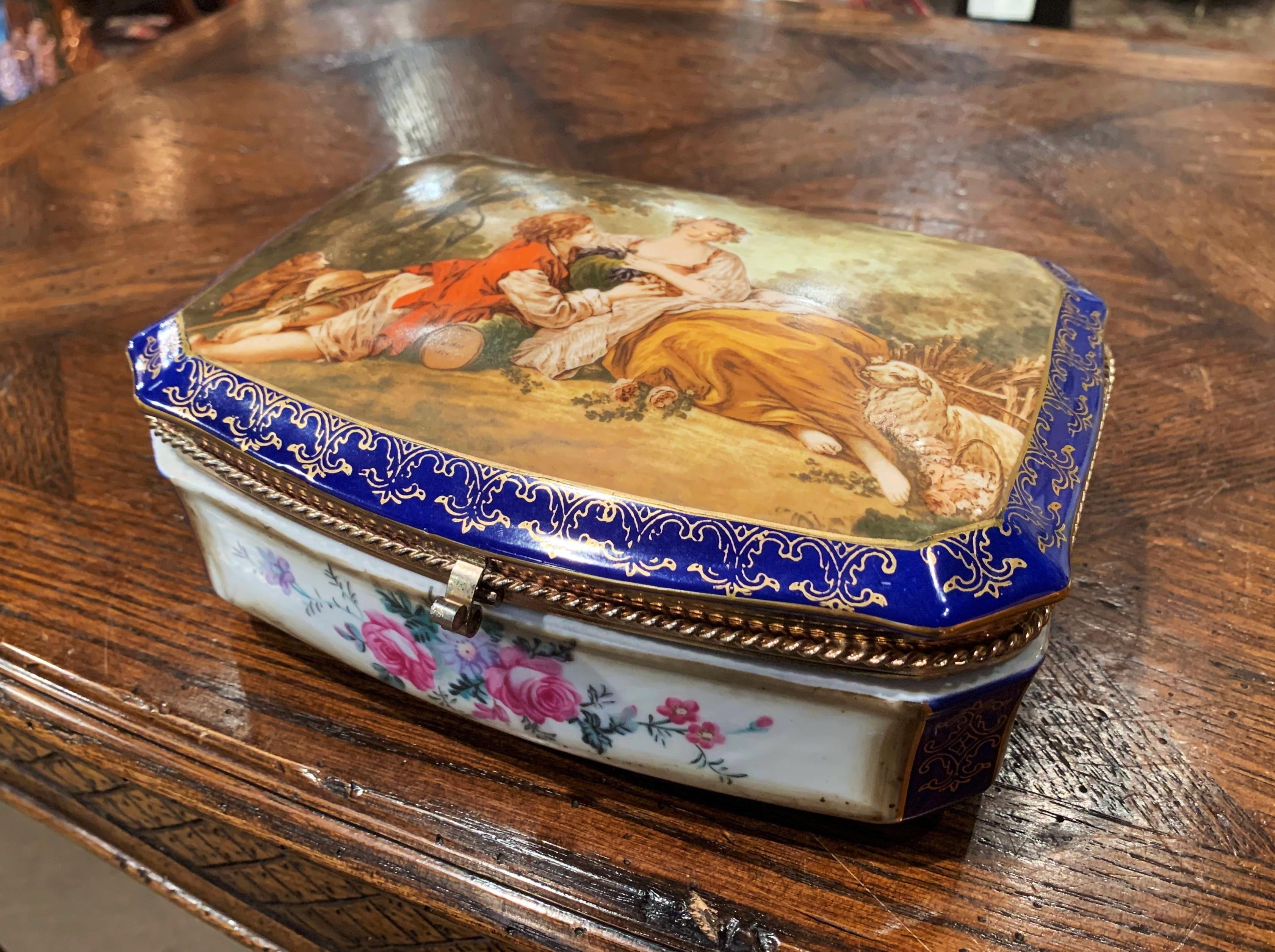 Decorate a master bathroom or powder room with this colorful antique jewelry box, crafted in Sevres, France circa 1870, the porcelain box with cobalt and gilt border features a hand painted courting scene after Francois Boucher, with a gentleman