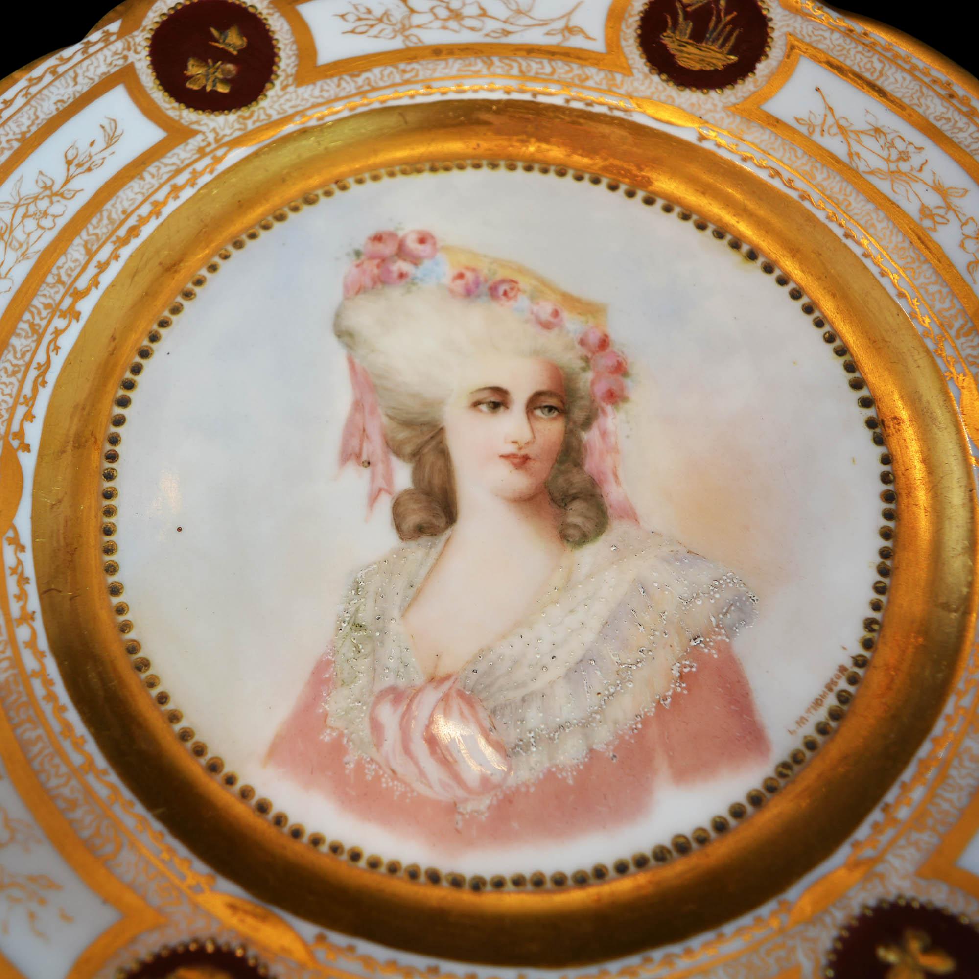 Antique French portrait plate signed by the artist. It features beautifully painted woman with floral adorned hat, rim with gilt scalloped edges and decorated with gilt garden motif, en verso stamped 