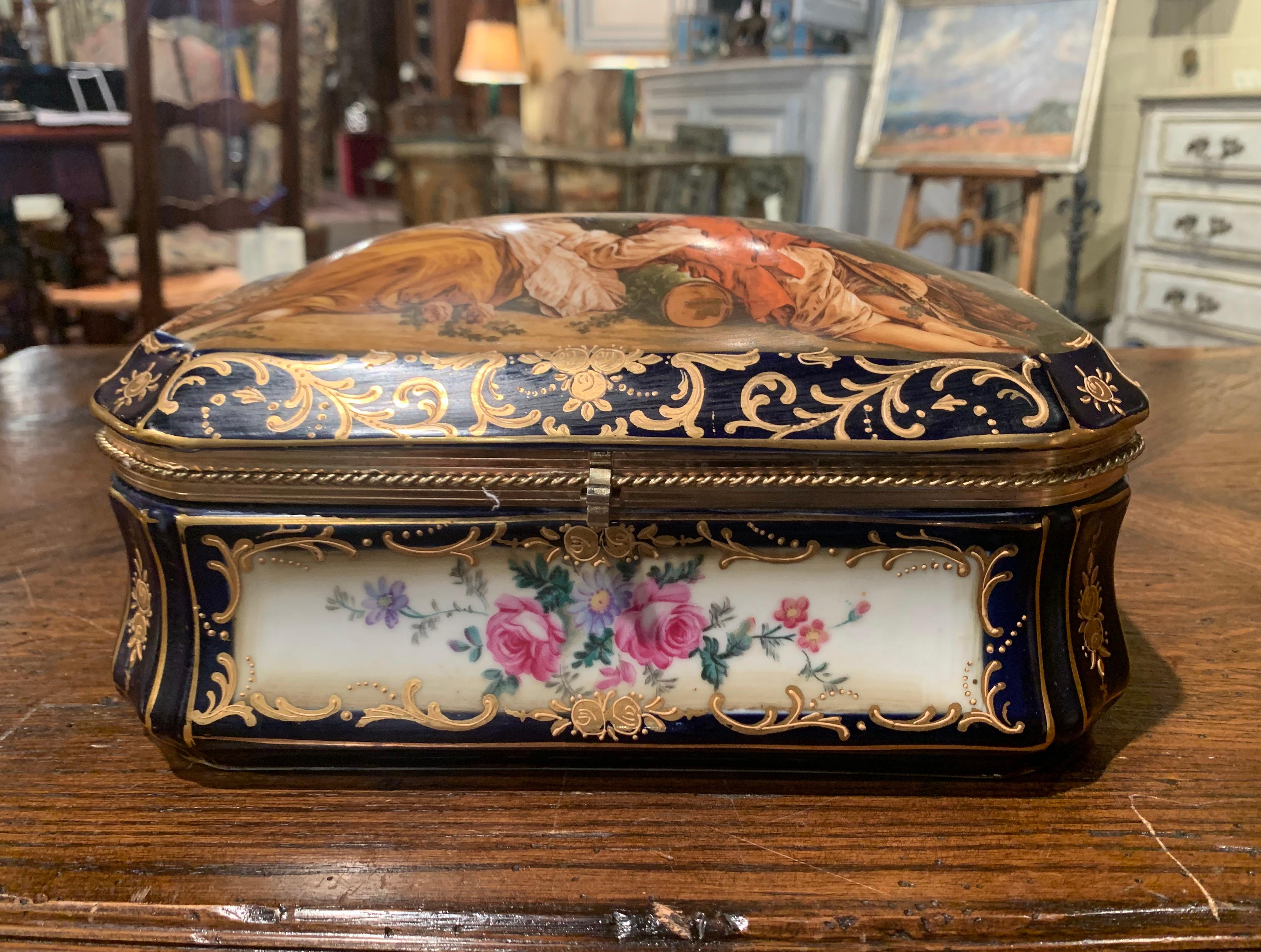 Decorate a master bathroom or powder room with this colorful antique jewelry box; crafted in the style of Sevres, France circa 1870, the porcelain bombe casket with cobalt blue and gilt border, features a hand painted pastoral scene after Francois