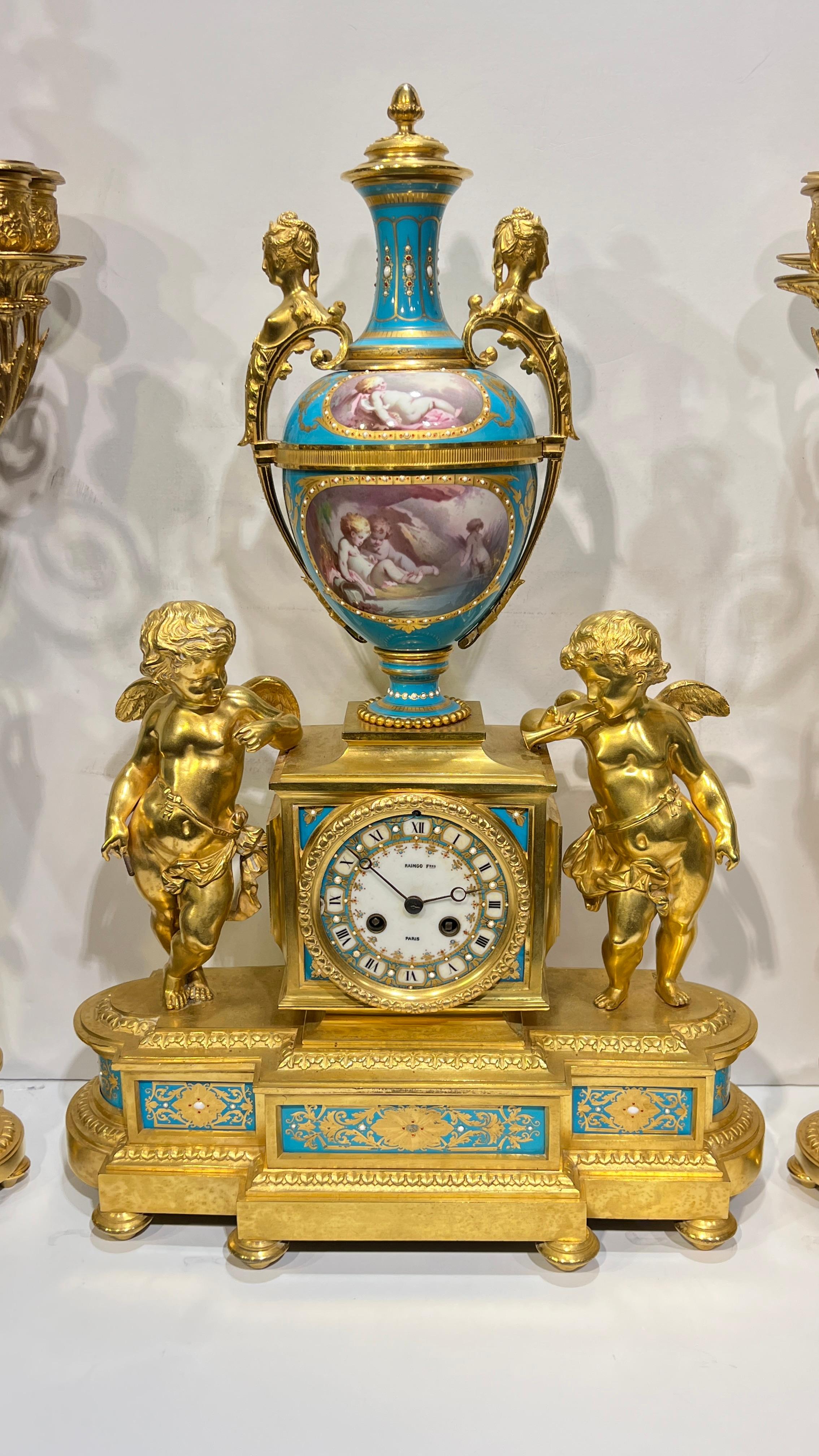 Finest quality French  sevres antique (late 19th century) garniture set including mantel clock and pair of candelabra by Raingo Freres of Paris, with clock movement by Vincenti et Cie, circa 1880s, featuring finely hand  painted and gilt Jeweled