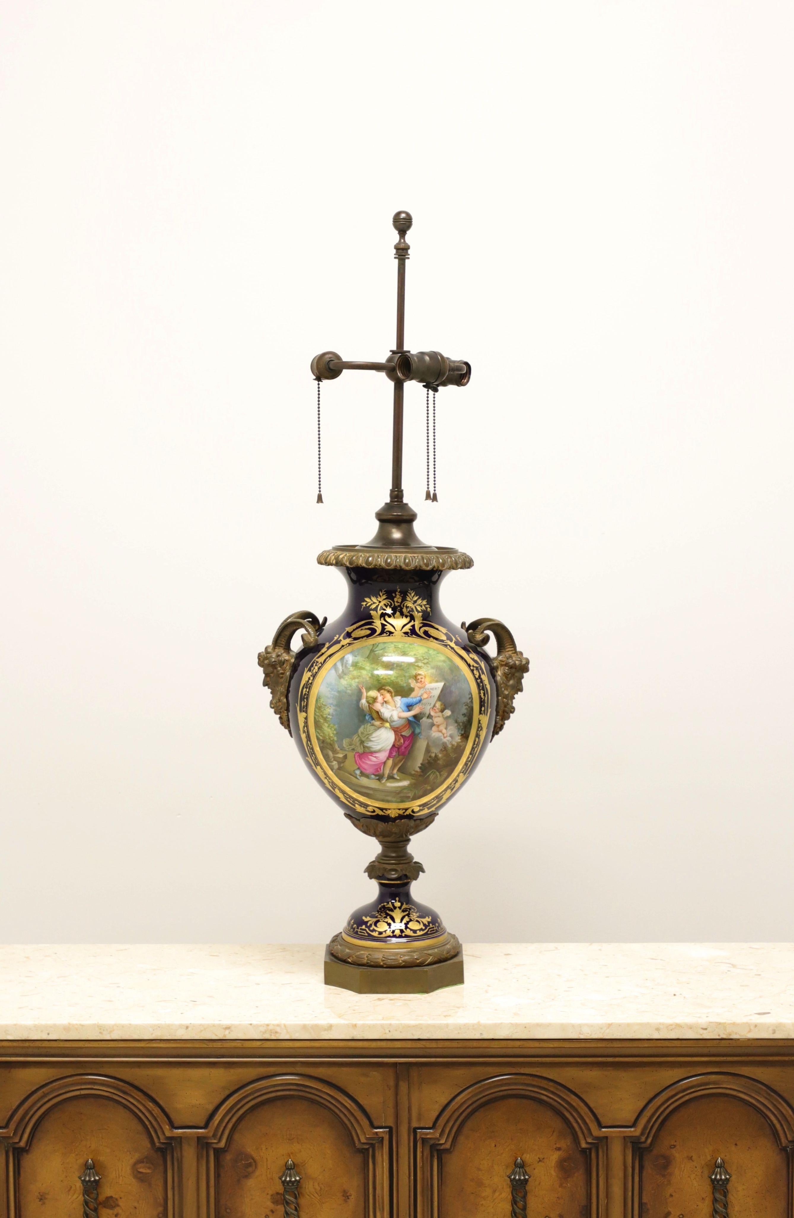 An antique French Sevres style porcelain urn mounted as a table lamp, unbranded. Sevres porcelain urn of dark blue & gold with hand painted scene of lovers kissing & cherubs on front and lake scene on back. Front scene is signed 