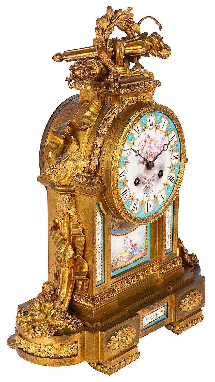 A good quality 19th century French gilded ormolu and Sevres style porcelain mantel clock. Having wreaths of foliage, arrows, sheaths, ribbons, and a pair of cornucopia on either side. The porcelain clock face with Roman numerals, an eight day