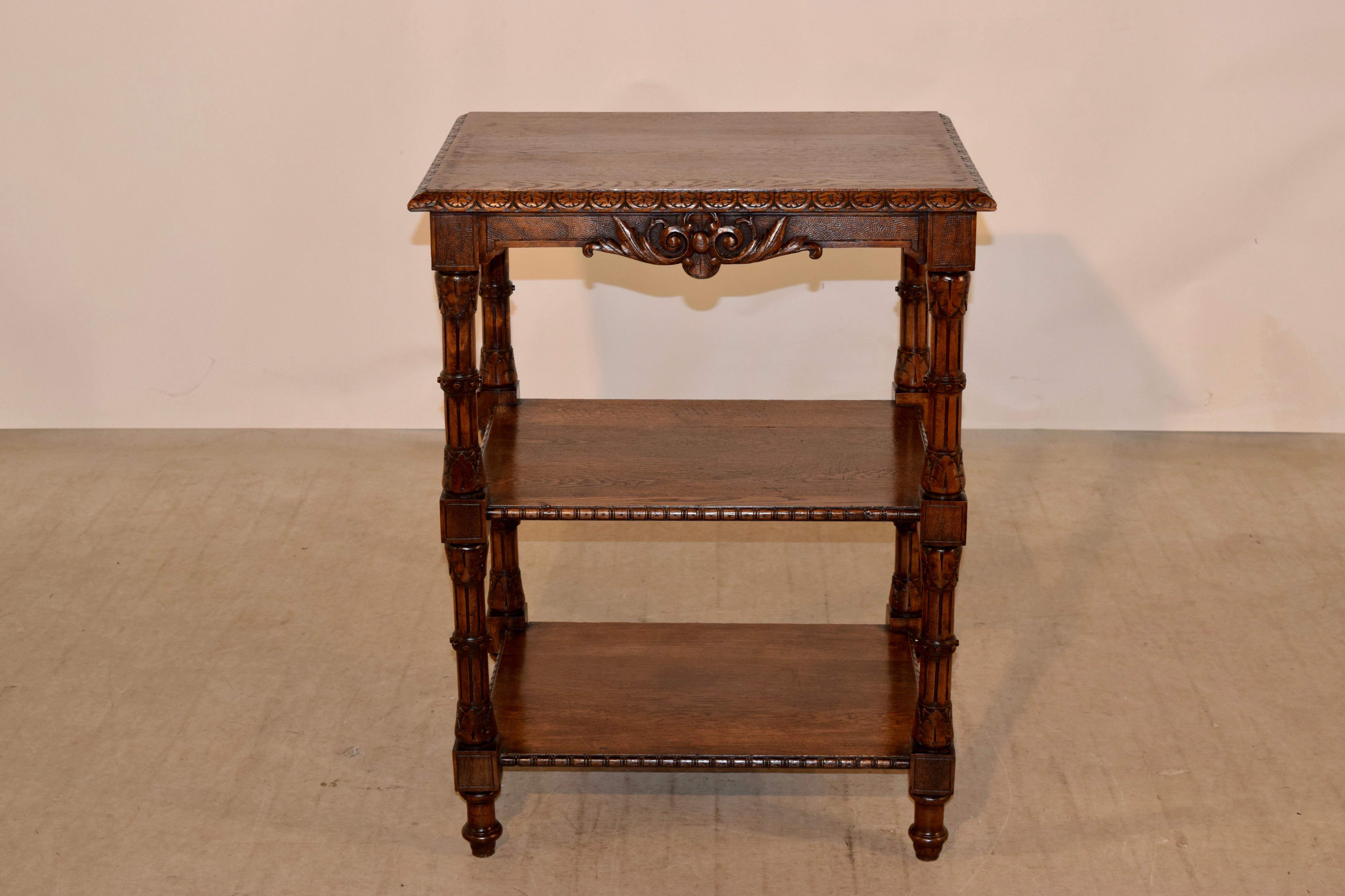 19th century French shelf with a beveled and carved decorated edge around the top, following down to simple molded aprons with lovely hand carved decorations and hand-turned and carved legs, which end in turned feet. There are two lower shelves,