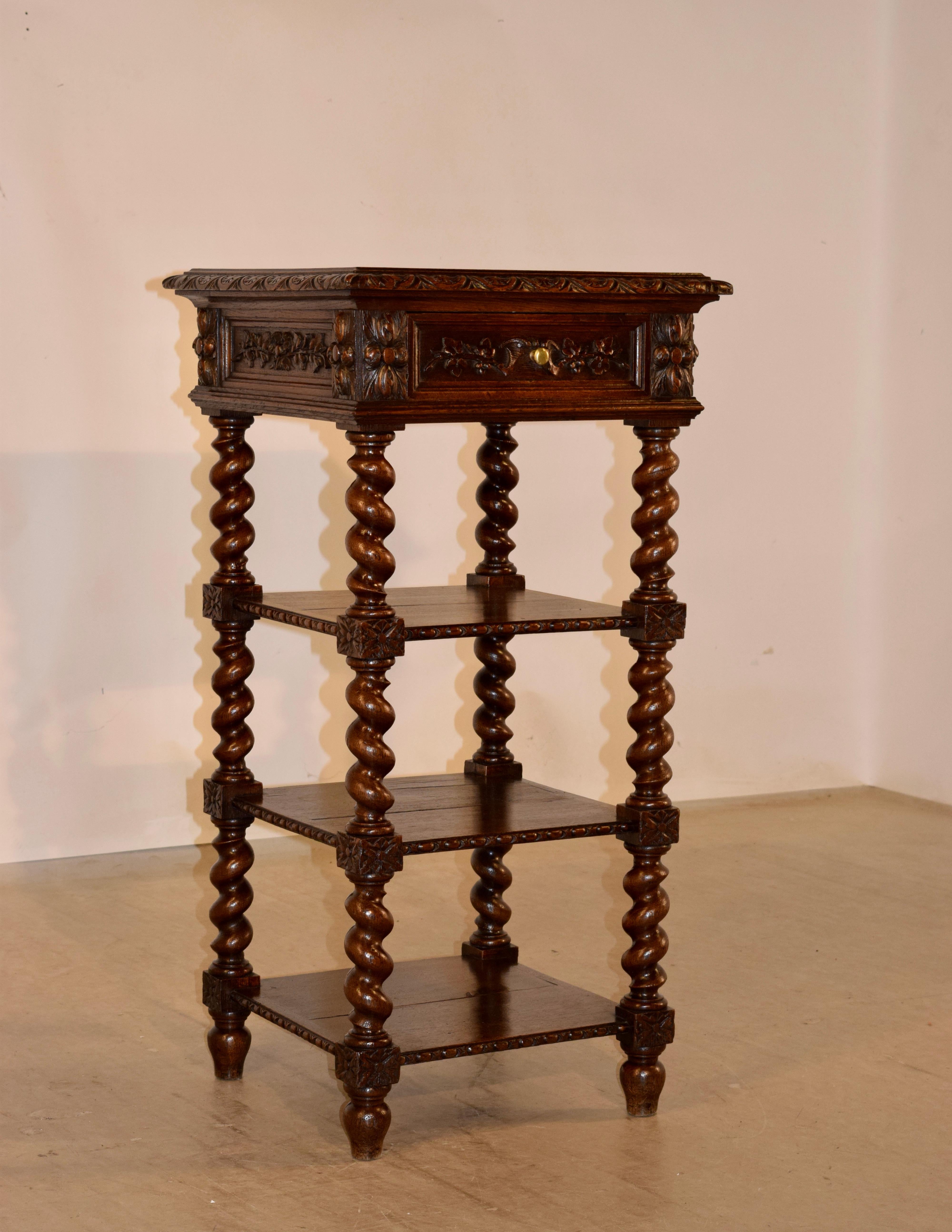 19th century oak shelf from France with a wonderfully beveled and carved decorated edge around the top, following down to paneled sides, which are adorned with hand carved decoration and molding. There is a single matching drawer in the front. The