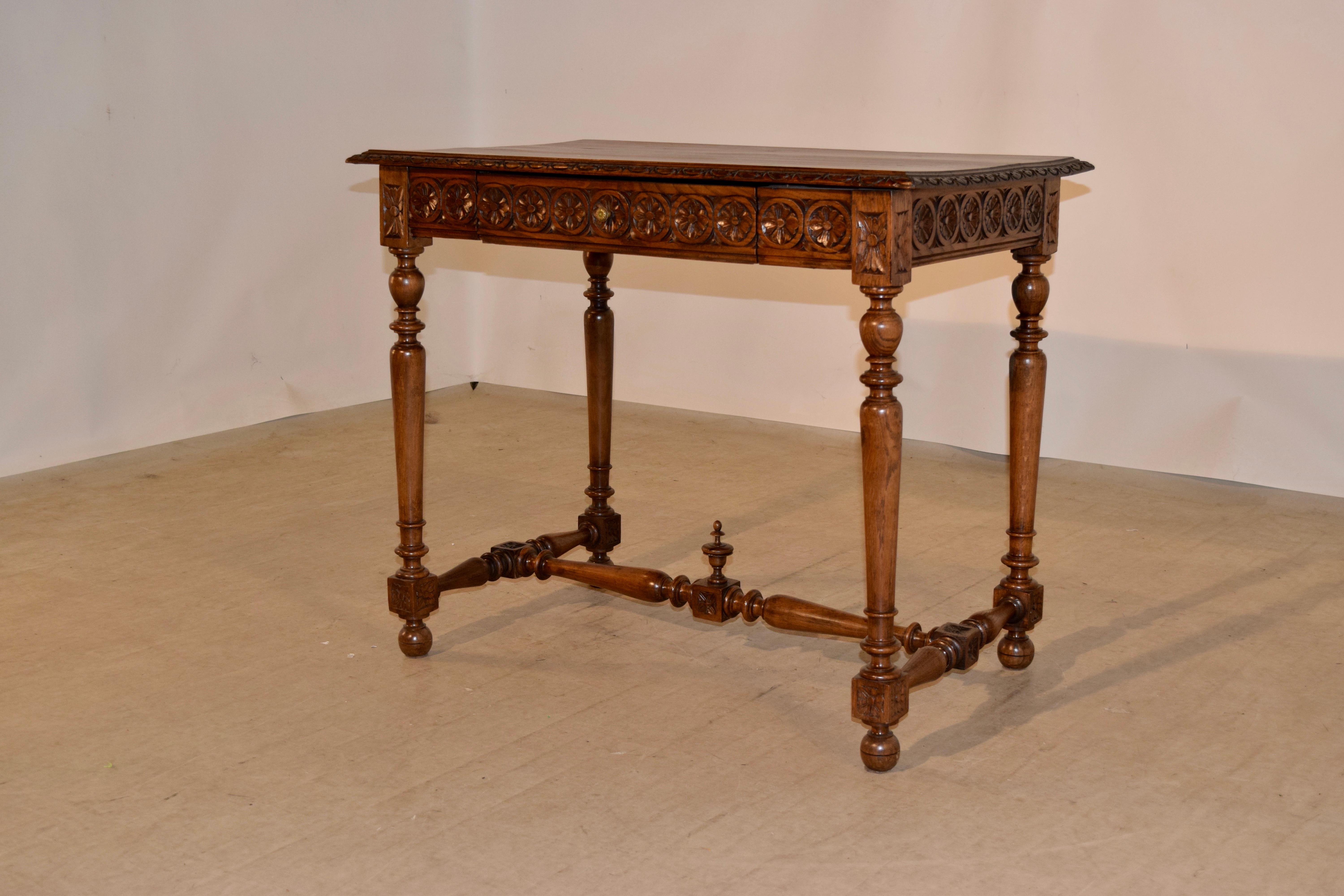 19th century oak side table made from oak with a wonderfully grained top which has a bevelled and gadrooned edge following down to a hand carved apron on all four sides for easy placement in any room. The apron contains a single drawer in the front.