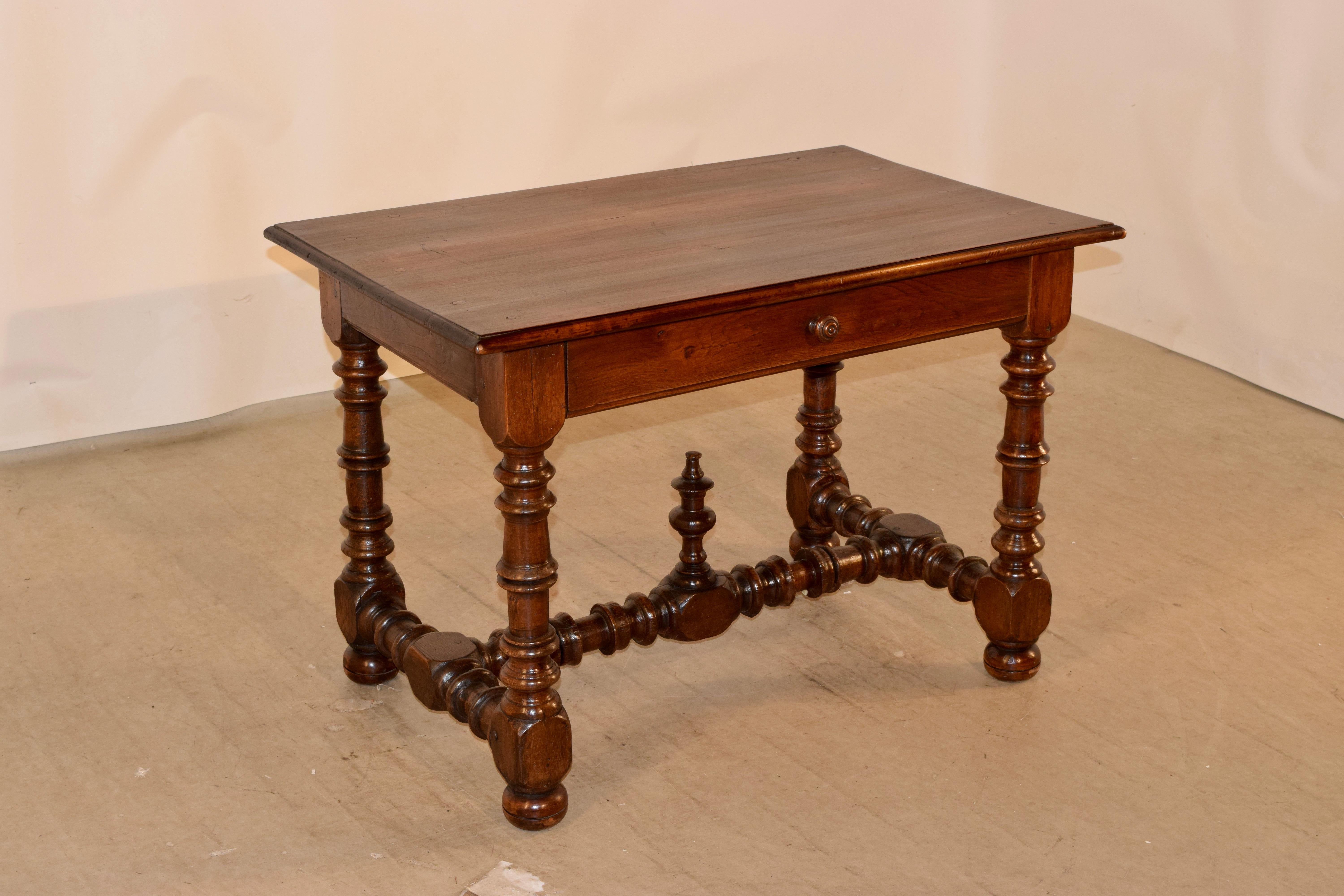 19th century walnut side table from France with a wonderfully grained four board top which has pegged construction and a beveled edge. This follows down to a simple apron with a single drawer in the front. The apron is finished on all four sides for