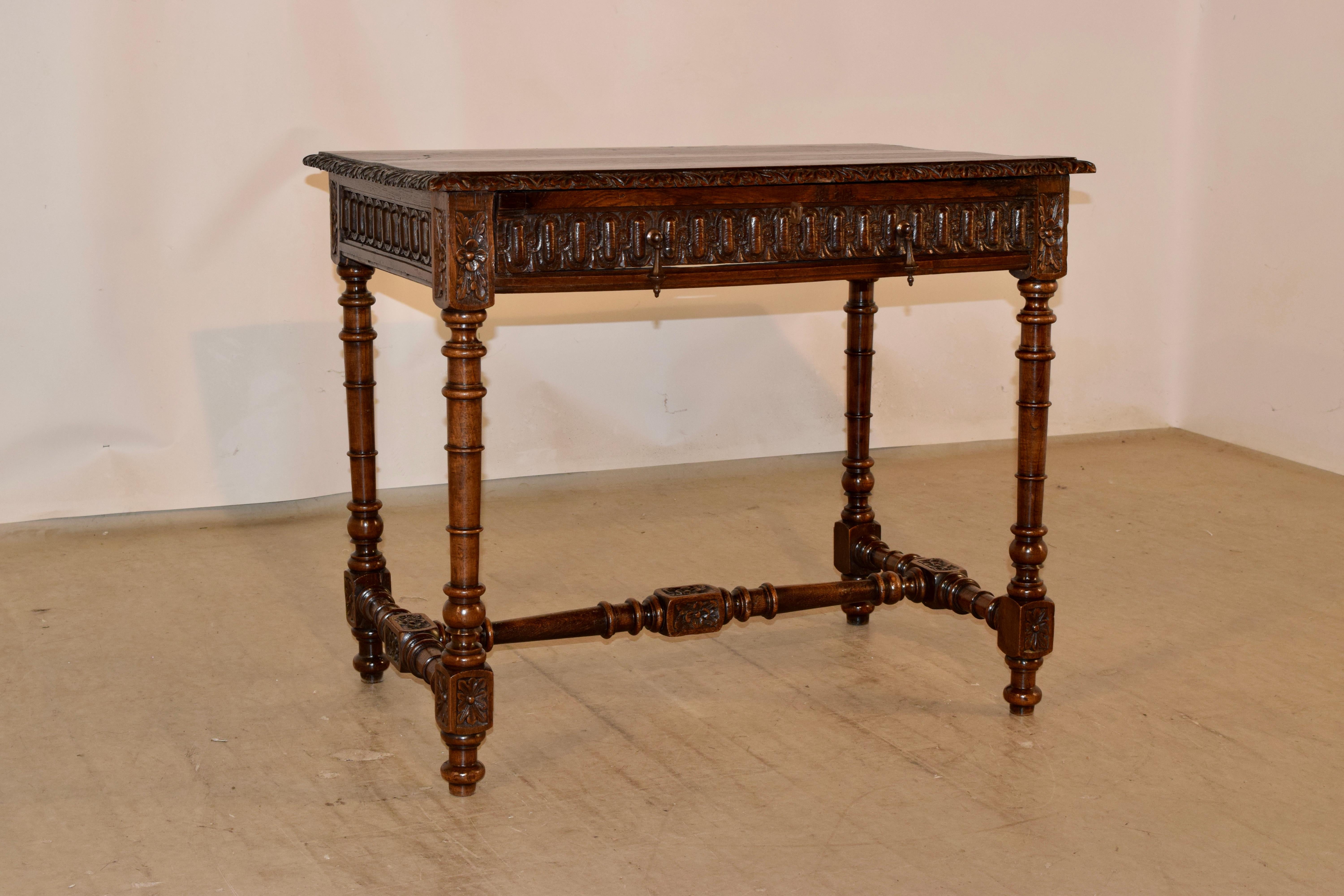 19th century walnut side table from France with a beveled and hand carved decorated edge around the top, following down to a fabulously hand carved apron on all four sides of the table for easy placement in any room. There is a single drawer in the