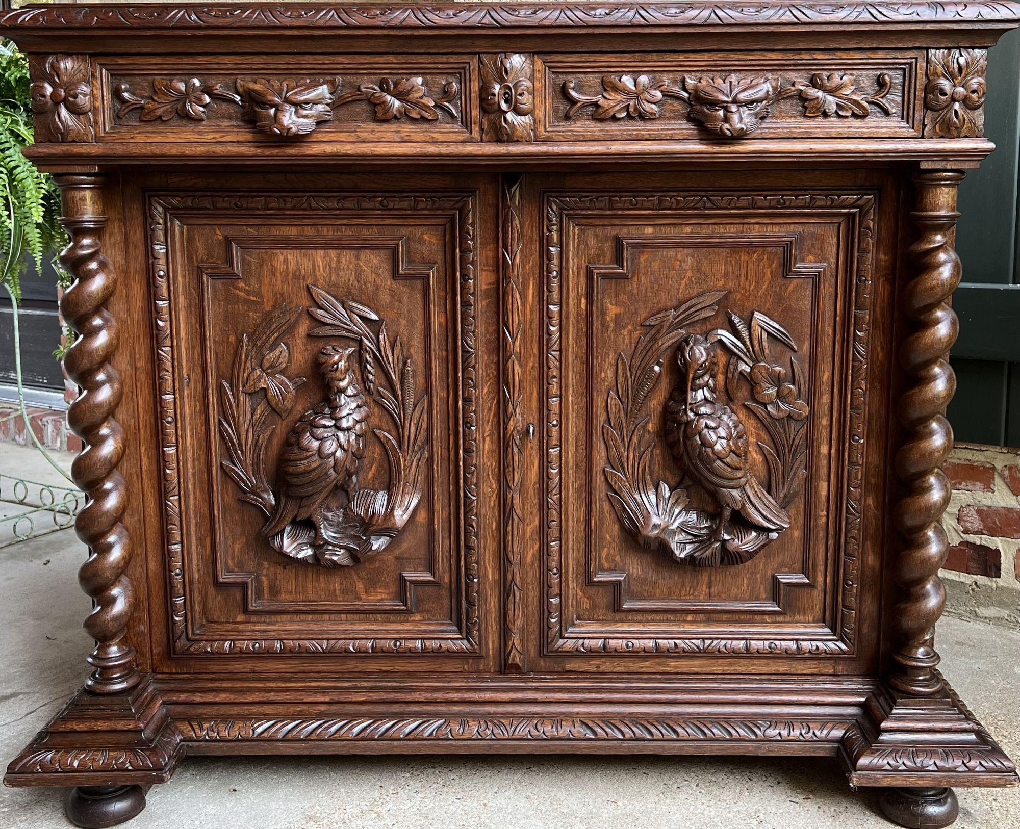 19th century French sideboard cabinet buffet black forest hunt barley twist oak.
 
Direct from France, a versatile, 4 ft. length, antique sideboard or buffet with exceptional hand carved features throughout.
Double drawers to the front, with each