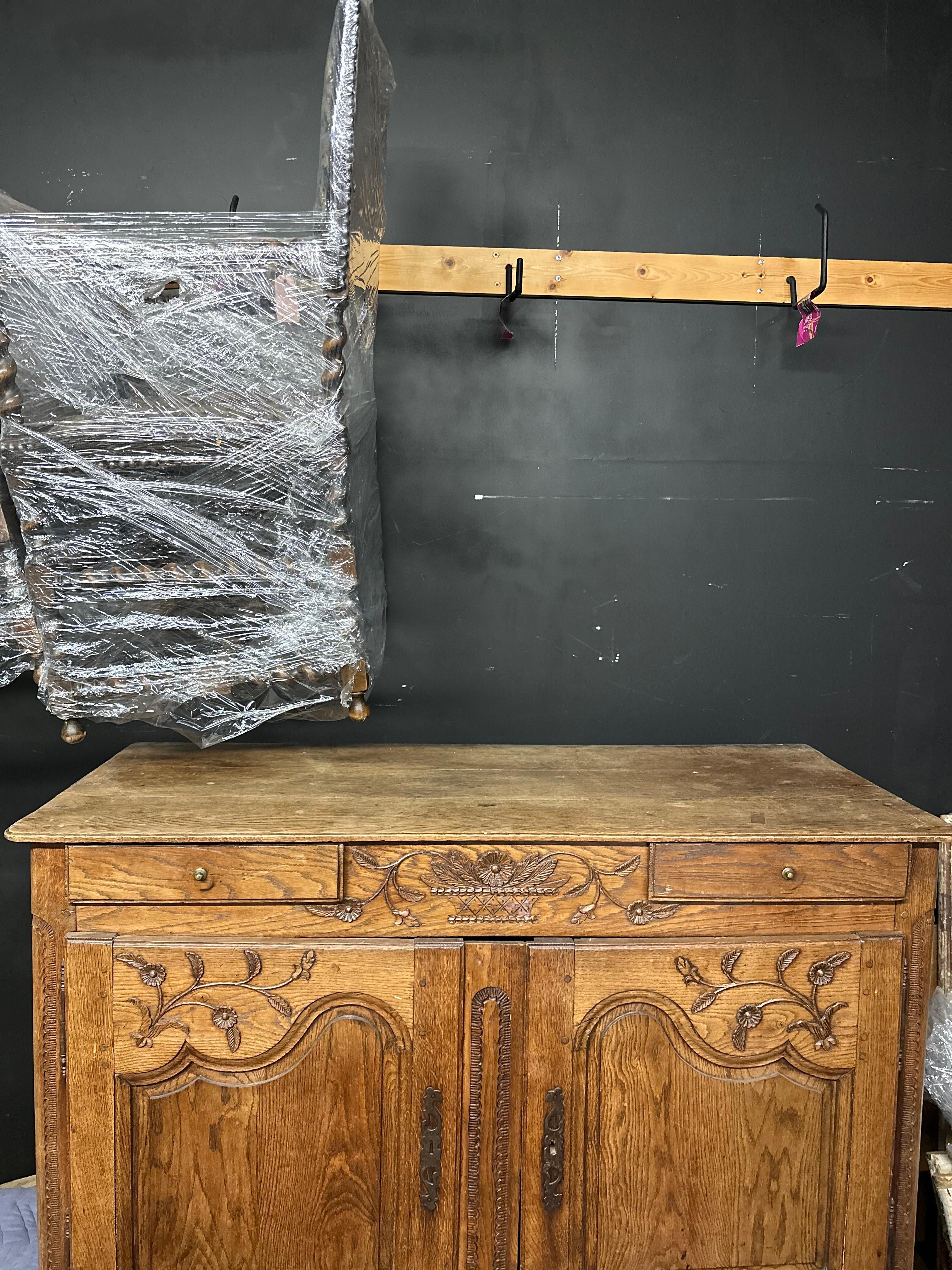 19th century French Sideboard with two front doors and two drawers. Beautiful character to the wood and fine hand-carvings on the top and bottom scalloped apron.