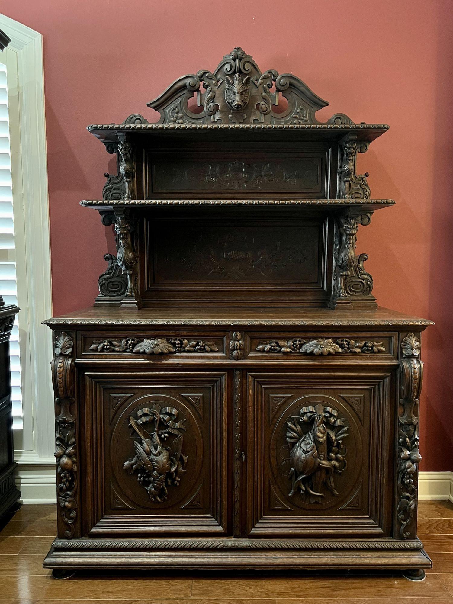 19th century French sideboard server buffet hunt cabinet black forest oak boar.
 
Direct from a castle estate in France, this very large 19th century carved French sideboard hunt cabinet! We recently purchased the entire contents of a gorgeous