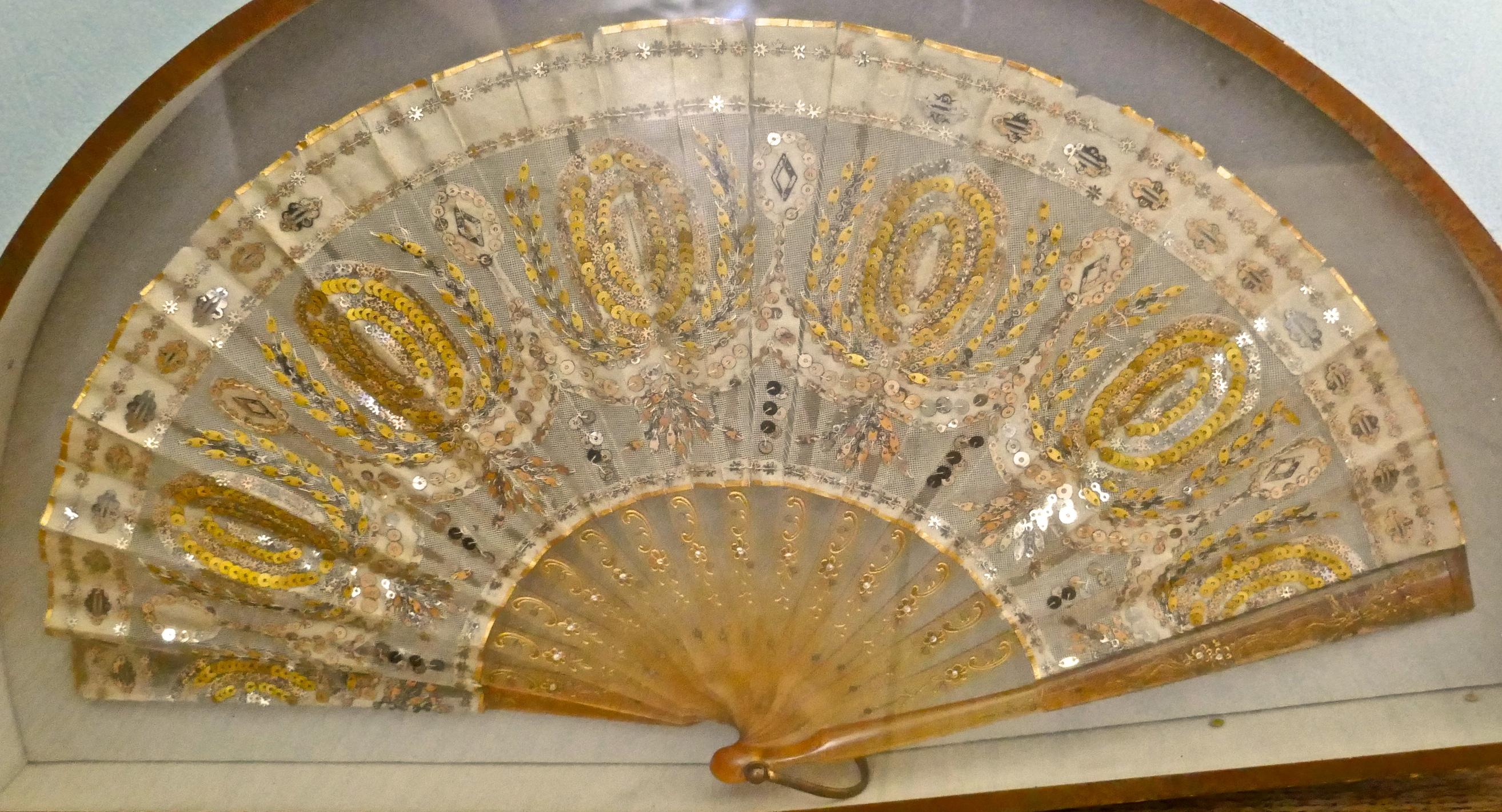19th Century French Silk, Gold and Silver Formal Evening Fan

A Beautiful treasured piece preserved in a purpose made Frame

The fan has the most superb detail, it is made in fine silk gauze and is decorated with tiny silver and gold sequins (all