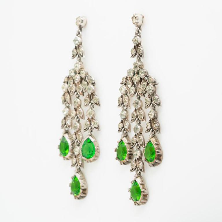 19th Century French Silver and Emerald and Clear Paste Girandole Earrings c.1880s

Additional Information:
Period: 19th. Century
Year: 1880s. 
Material: Silver, Emerald and Clear Paste (cut glass)
Closure: Post
Weight: 22.4g
Length: 75.4mm
Width: