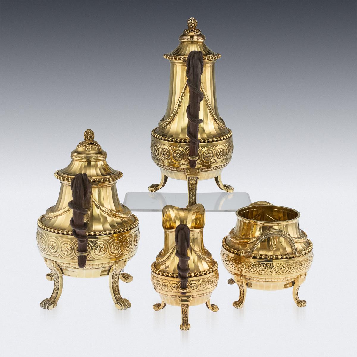 Antique 19th century exceptional French Louis XVI style silver-gilt four piece tea set, comprising of a coffee pot, teapot, sugar bowl and cream jug, all richly gilt throughout. Each piece standing on cast scroll feet, decorated with laurel leaves