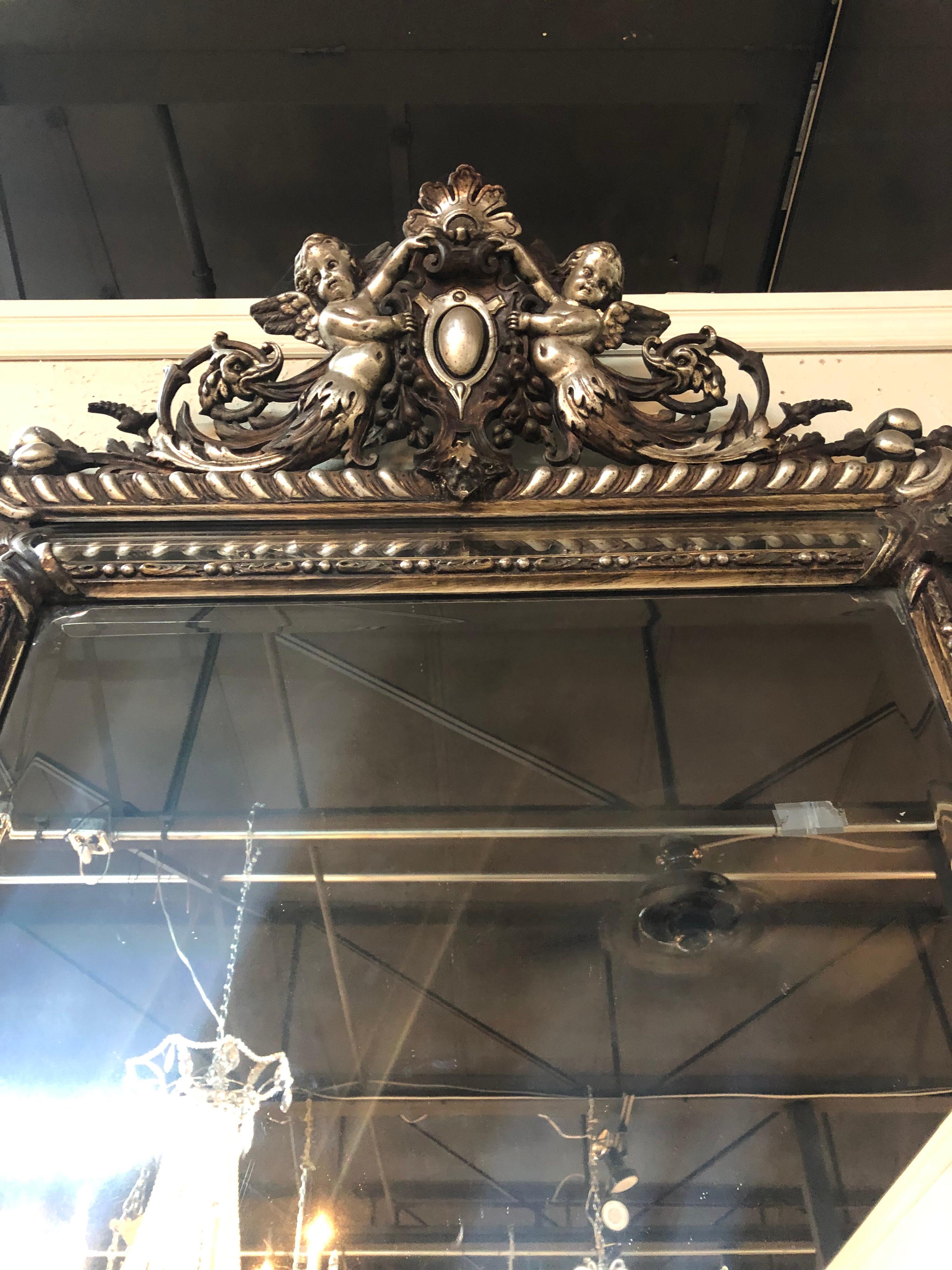 Beautiful 19th century French carved silver gilt cushion mirror with a pair of cherubs at the top. Very fine carving and gilt on this piece.