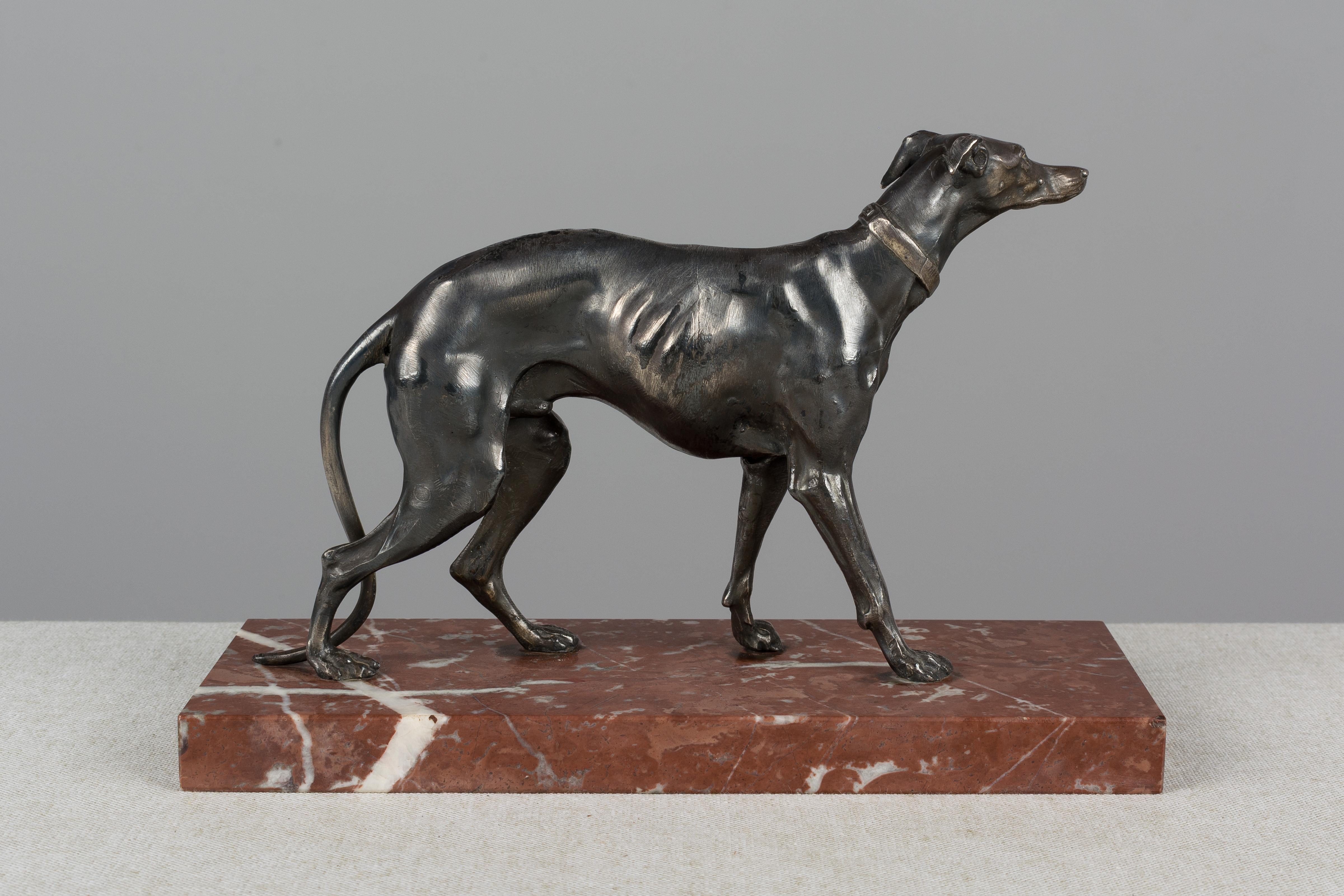 A 19th century French silver patinated bronze greyhound on a red marble base. A beautiful depiction of this sleek handsome dog. In very good condition with slight wear to the patina. Unsigned, but in the style of Emmanuel Fremiet (French 1824-1910).