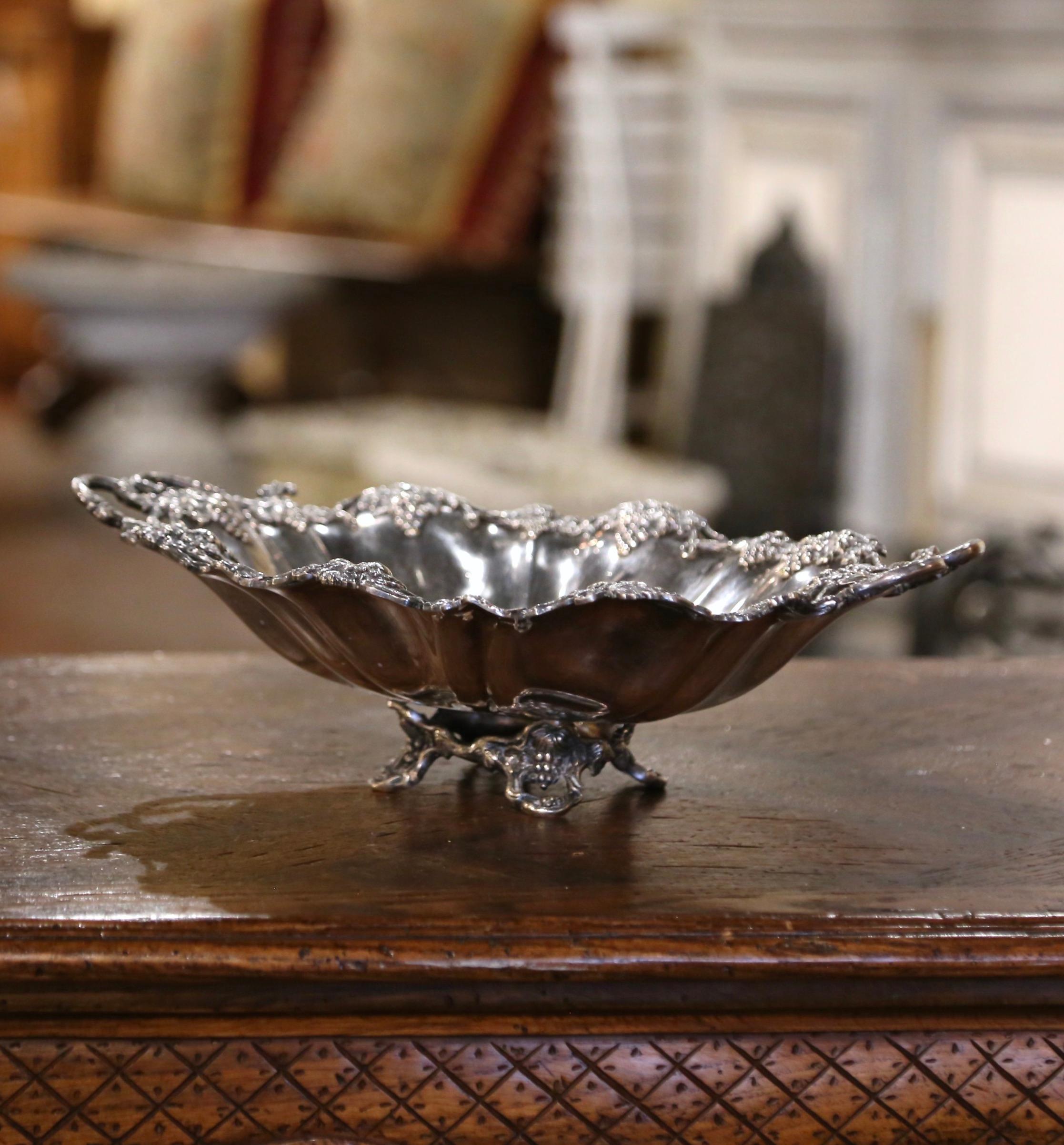 Serve your baguette or crackers in style in this elegant bread tray. Crafted in France circa 1870 and oval in shape with side handles, the dish stands on four feet, and features intricate grape and vine motifs in high relief. The display tray is in