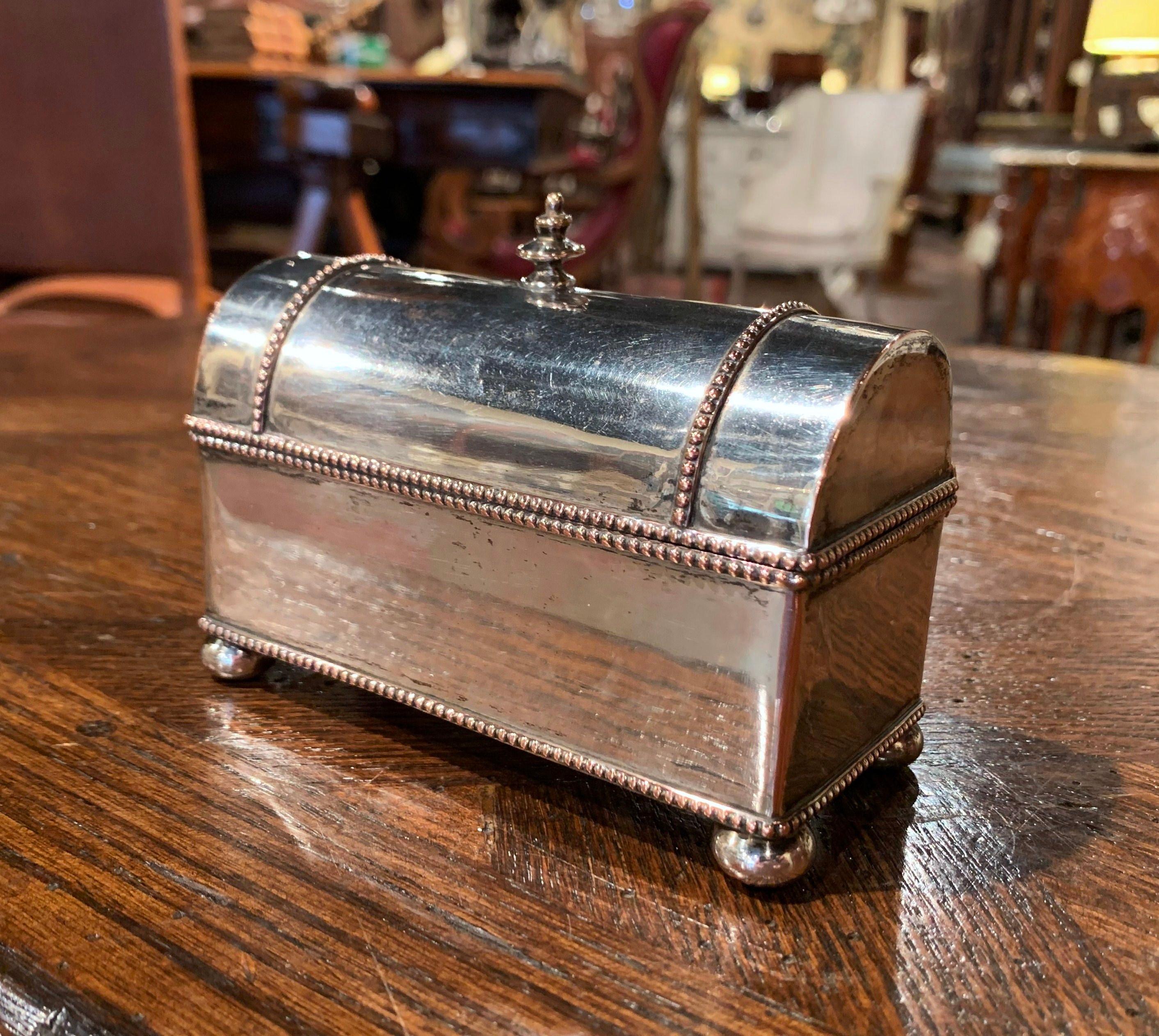 This elegant antique inkwell was created in France circa 1880, made of copper and silver plated, the trunk shape desk accessory stands on bun feet, and the bombe top opens to reveal two inside square glass ink containers. The small inkwell with bead
