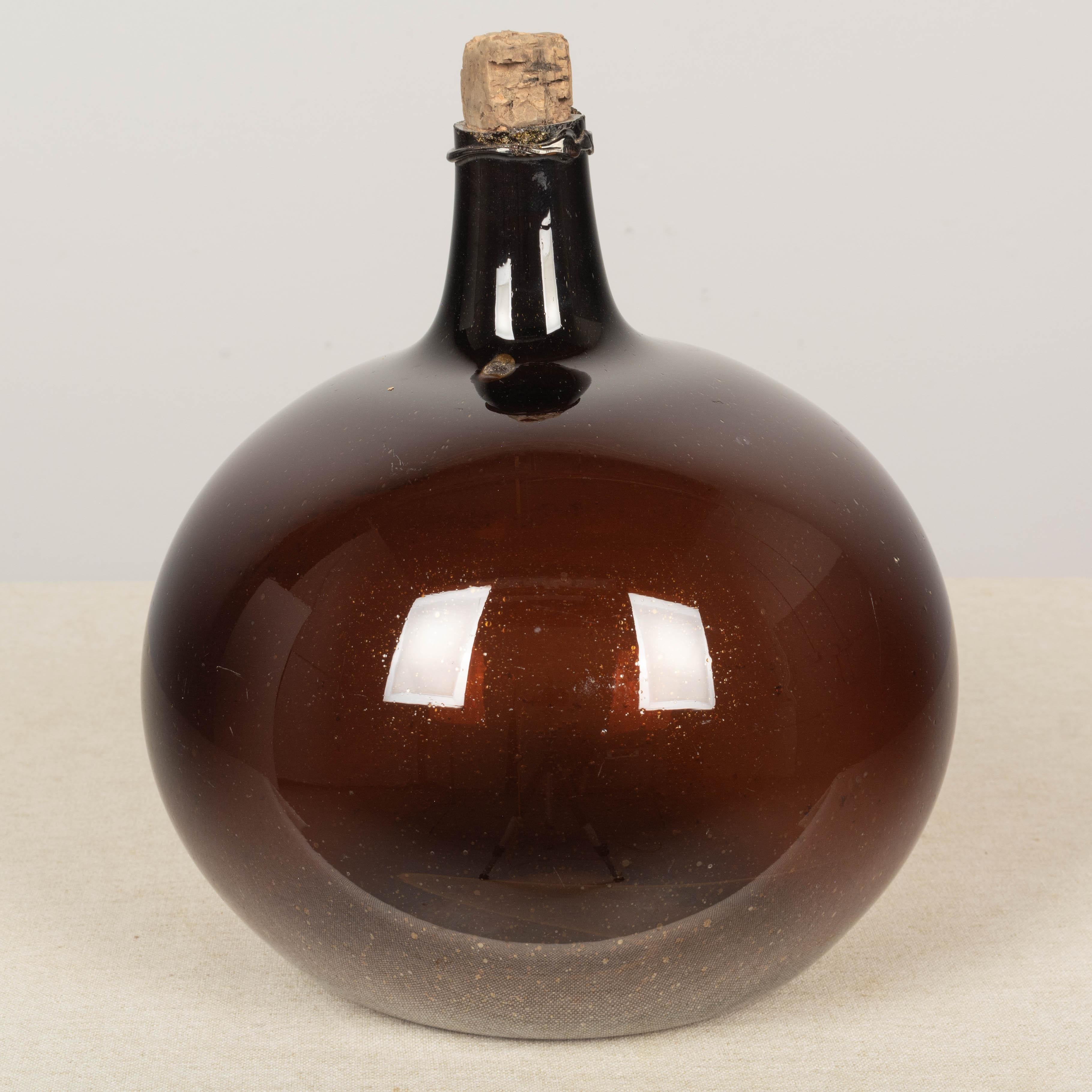 Hand-Crafted 19th Century French Small Amber Glass Demijohn Bottle