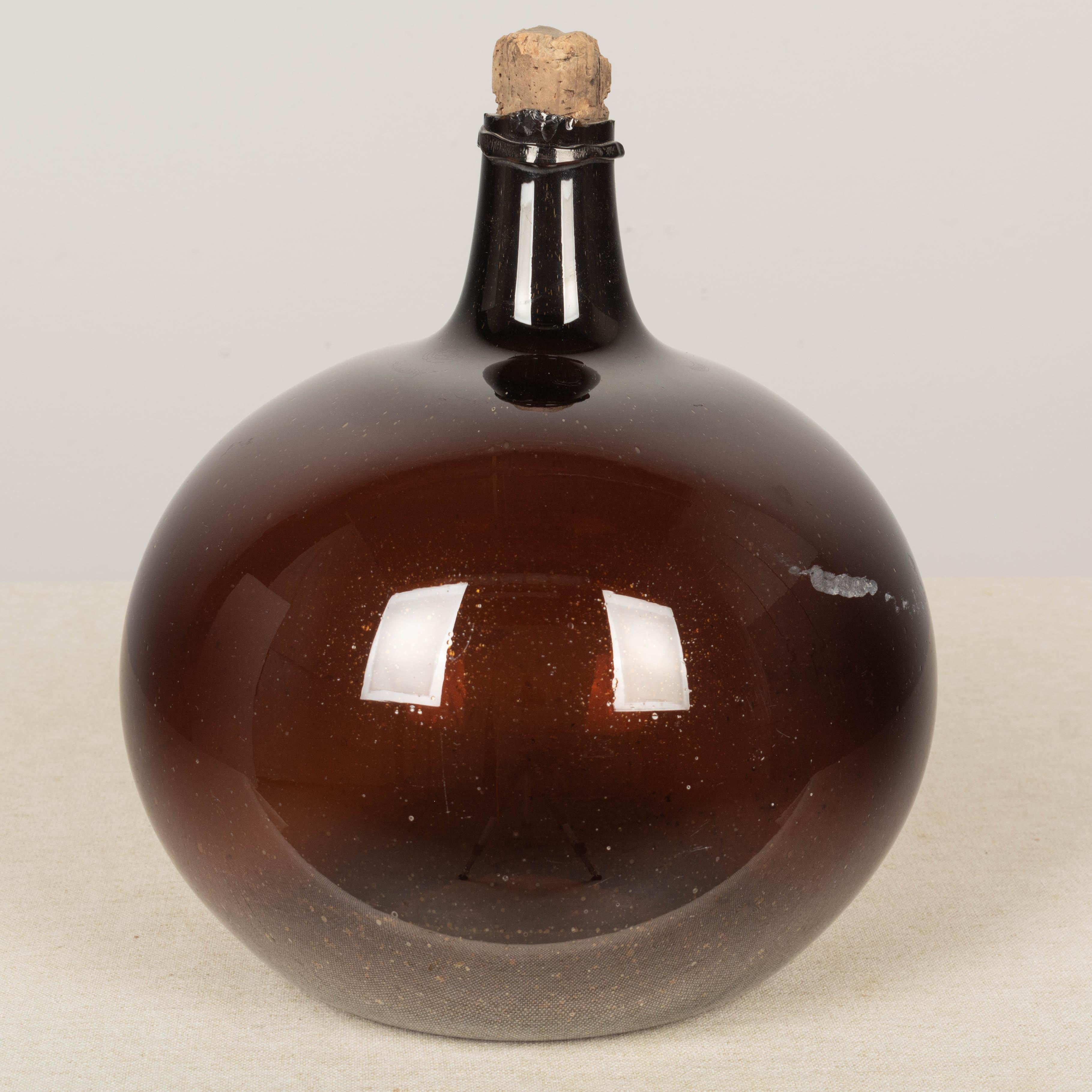 Cork 19th Century French Small Amber Glass Demijohn Bottle