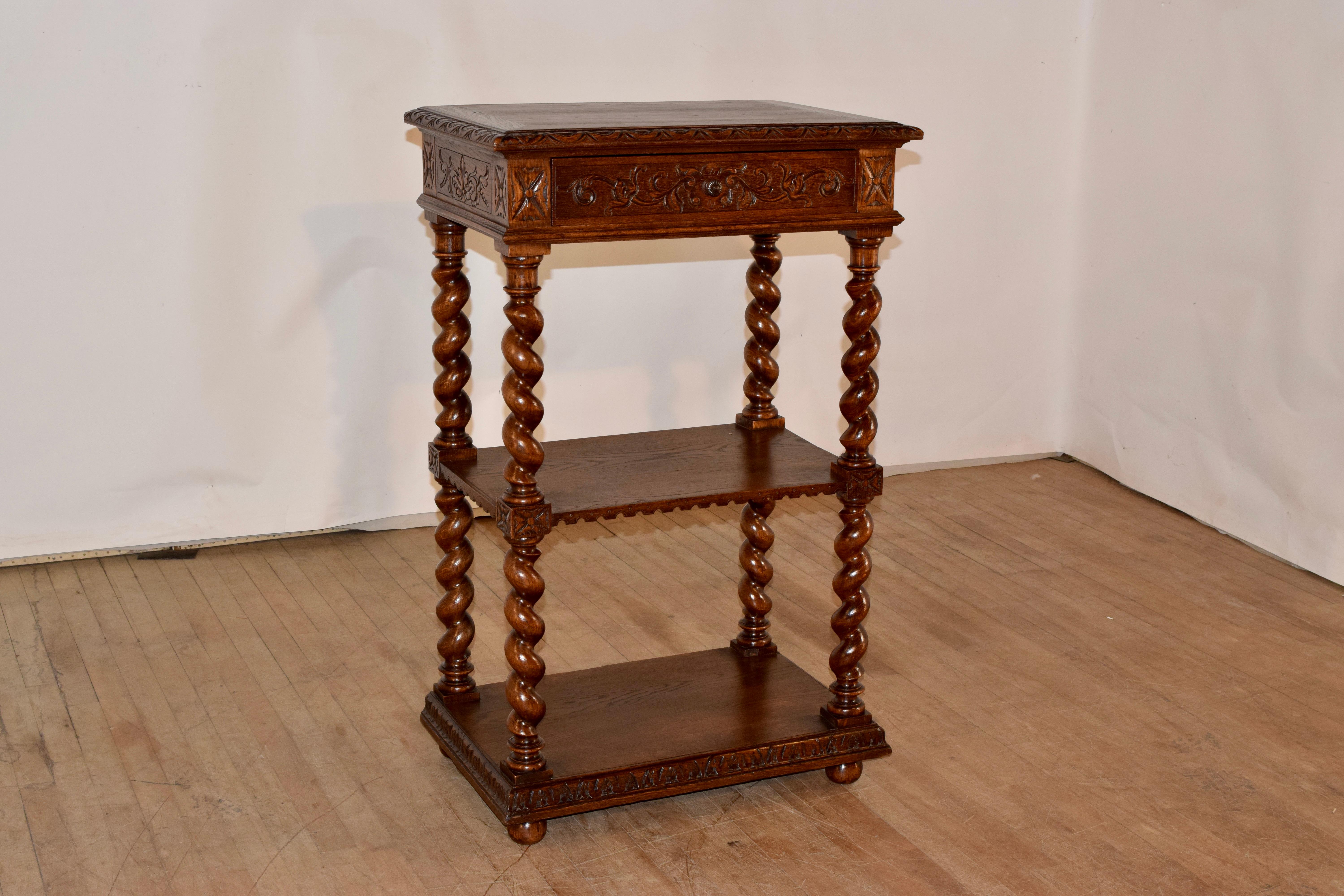 19th century oak small buffet from France. The top has a beveled edge which is carved decorated as well. The sides are hand-carved decorated and contain a single drawer in the front. The piece has hand turned barley twist legs, joined by two