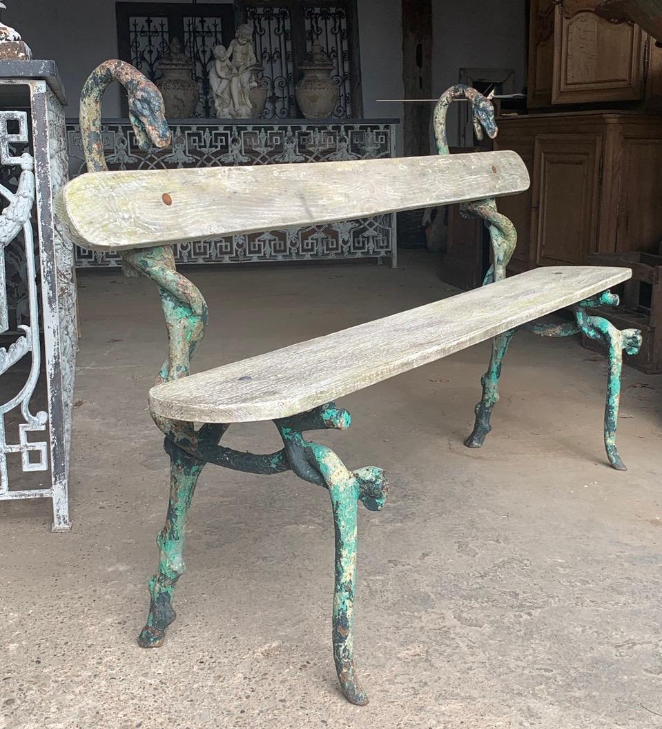 A lovely 19th century iron and wood garden bench from the south of France. The iron is in the form of Snakes which have lovely old original worn paint. A very nice quality bench which is a very rare model.