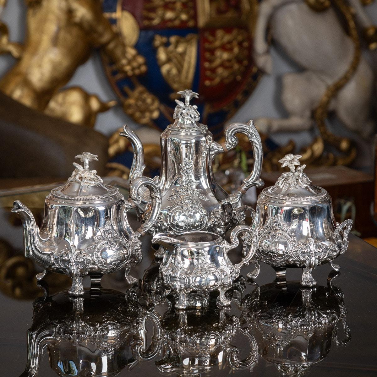 Antique late-19th Century French solid silver four piece tea & coffee service, comprising of a coffee pot, tea pot, lidded sugar bowl and cream jug, each shaped body standing on a scroll feet, the body chased and embossed with intertwining scrolls,