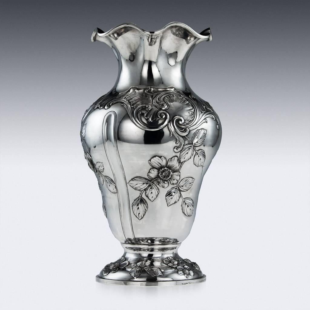 Antique 19th century French solid silver vase, the inverted pear shaped body is embossed with rococo leaves and flowers, standing on a domed foot decorated in the same manner. Hallmarked French silver (Minerva, 950 standard), Paris, Maker HV (Henin